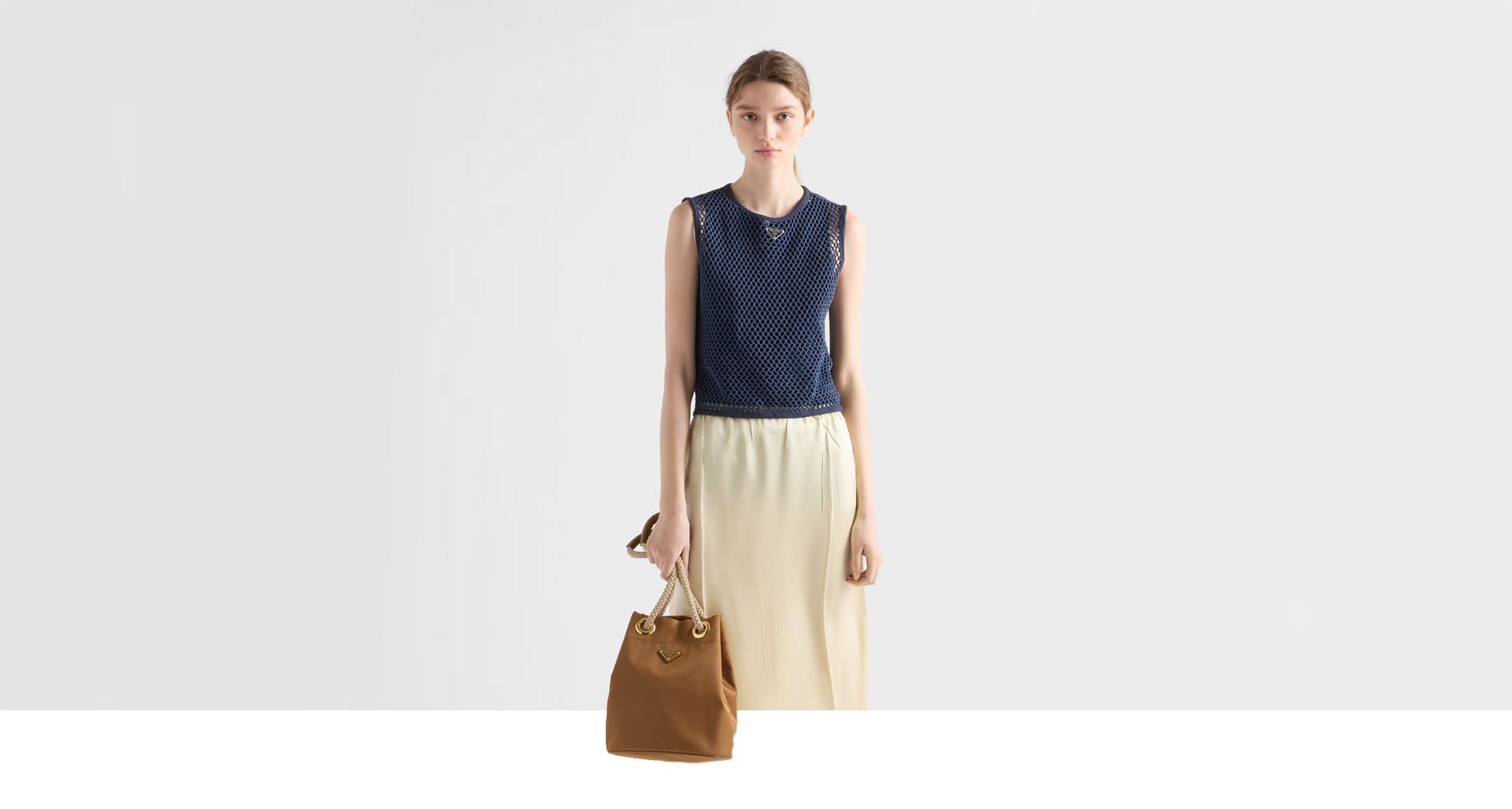 A stylish handbag sits outdoors on a stone wall.