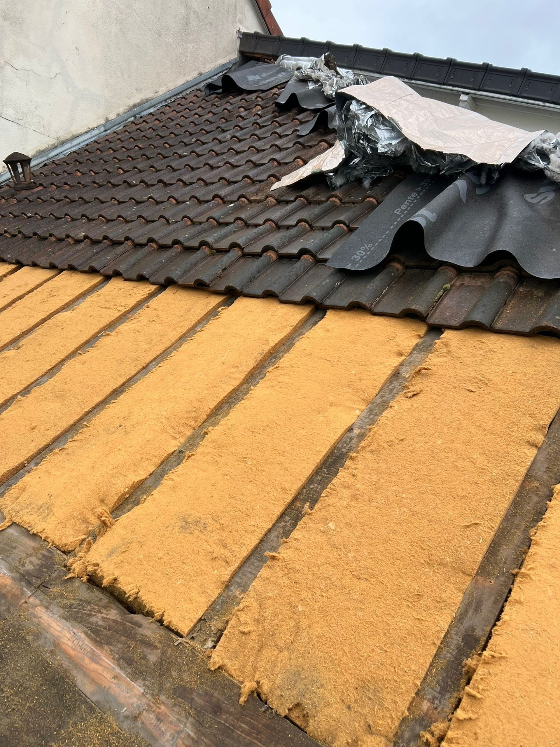 person in blue pants sitting on brown wooden floor