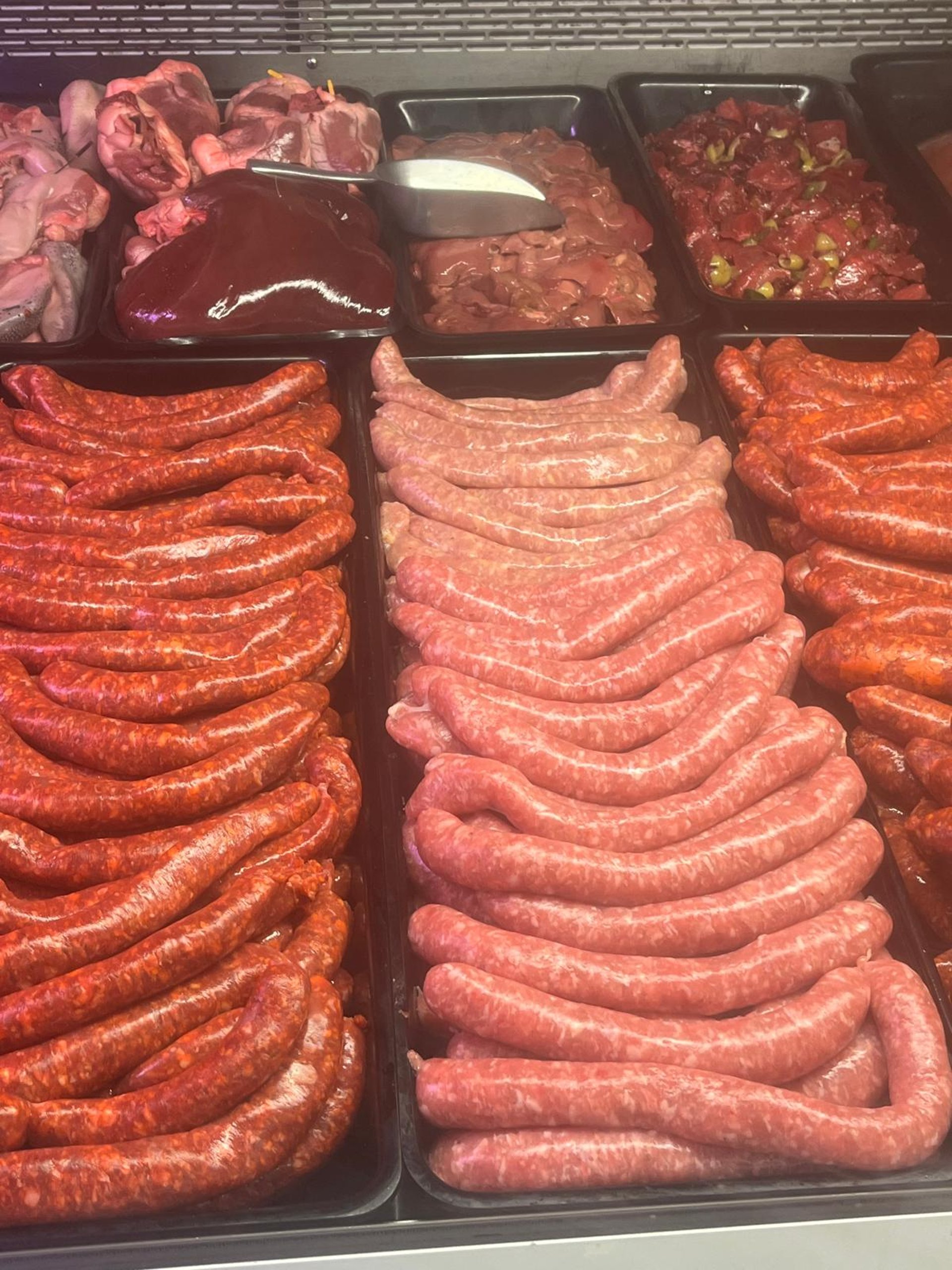 woman in black headphones holding black and silver headphones