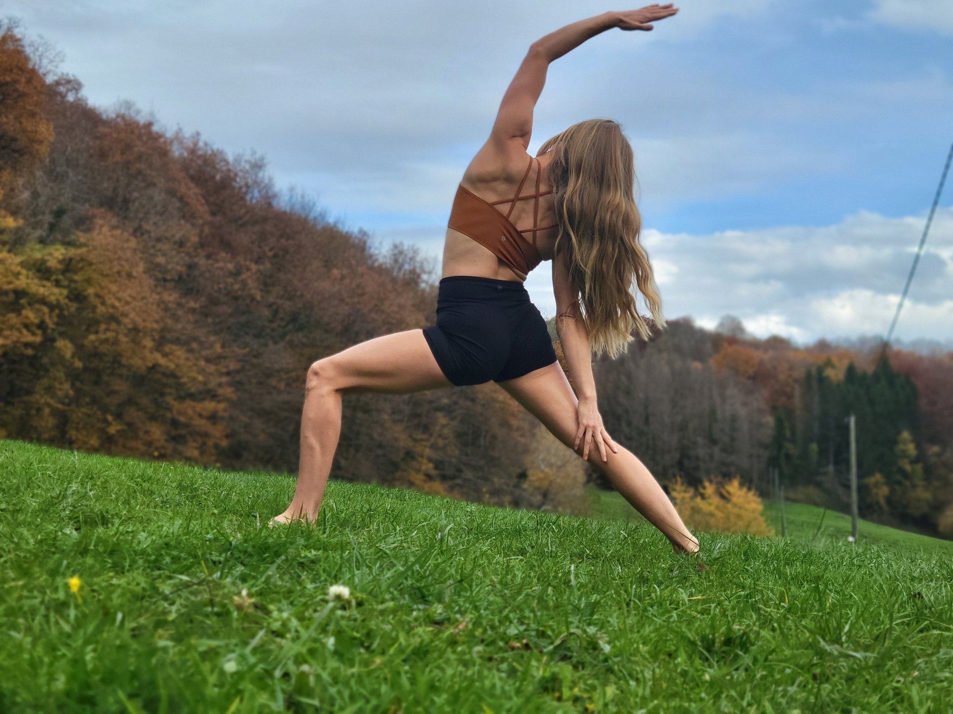 a woman doing a push up on a wooden floor
