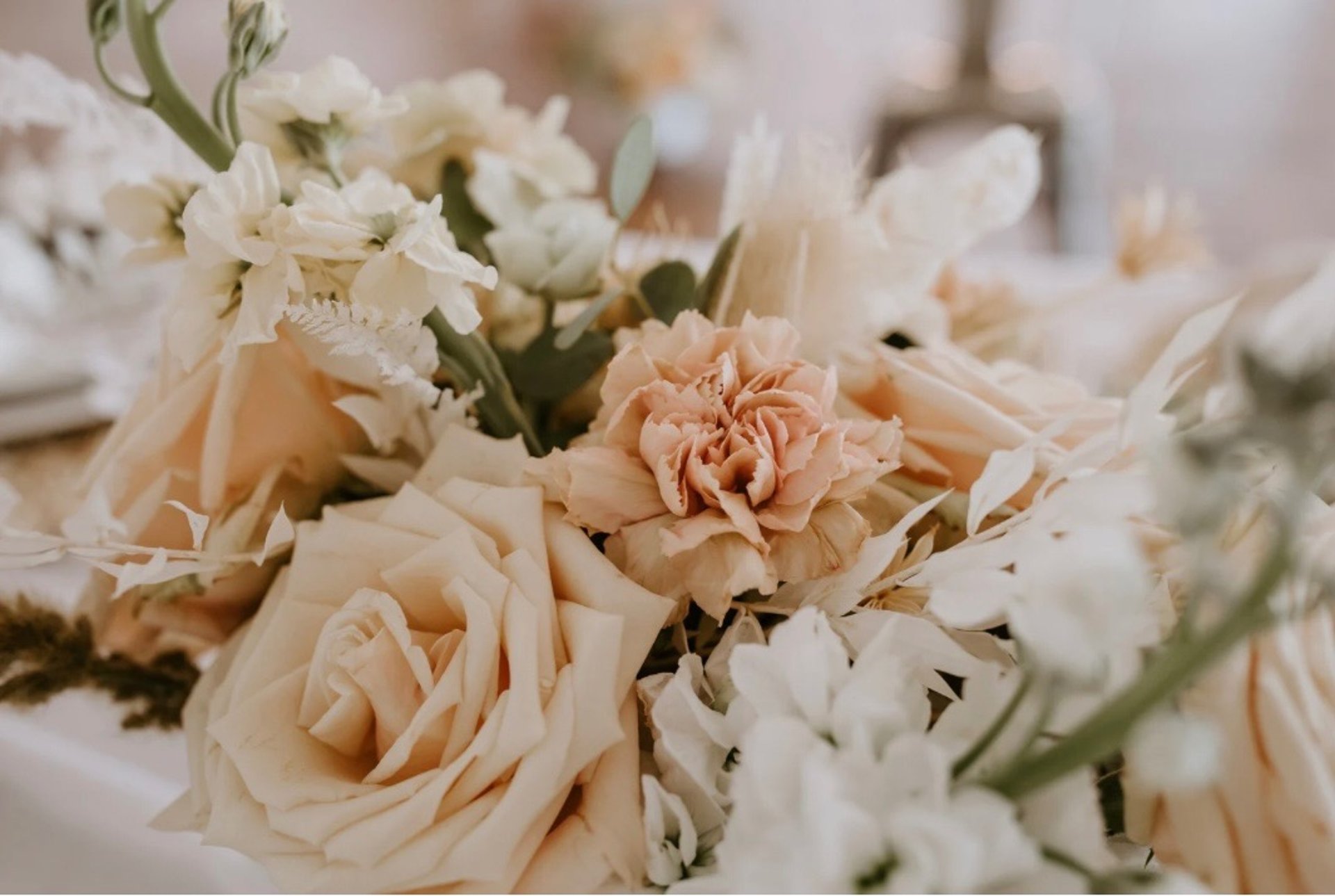 a table topped with lots of vases filled with flowers