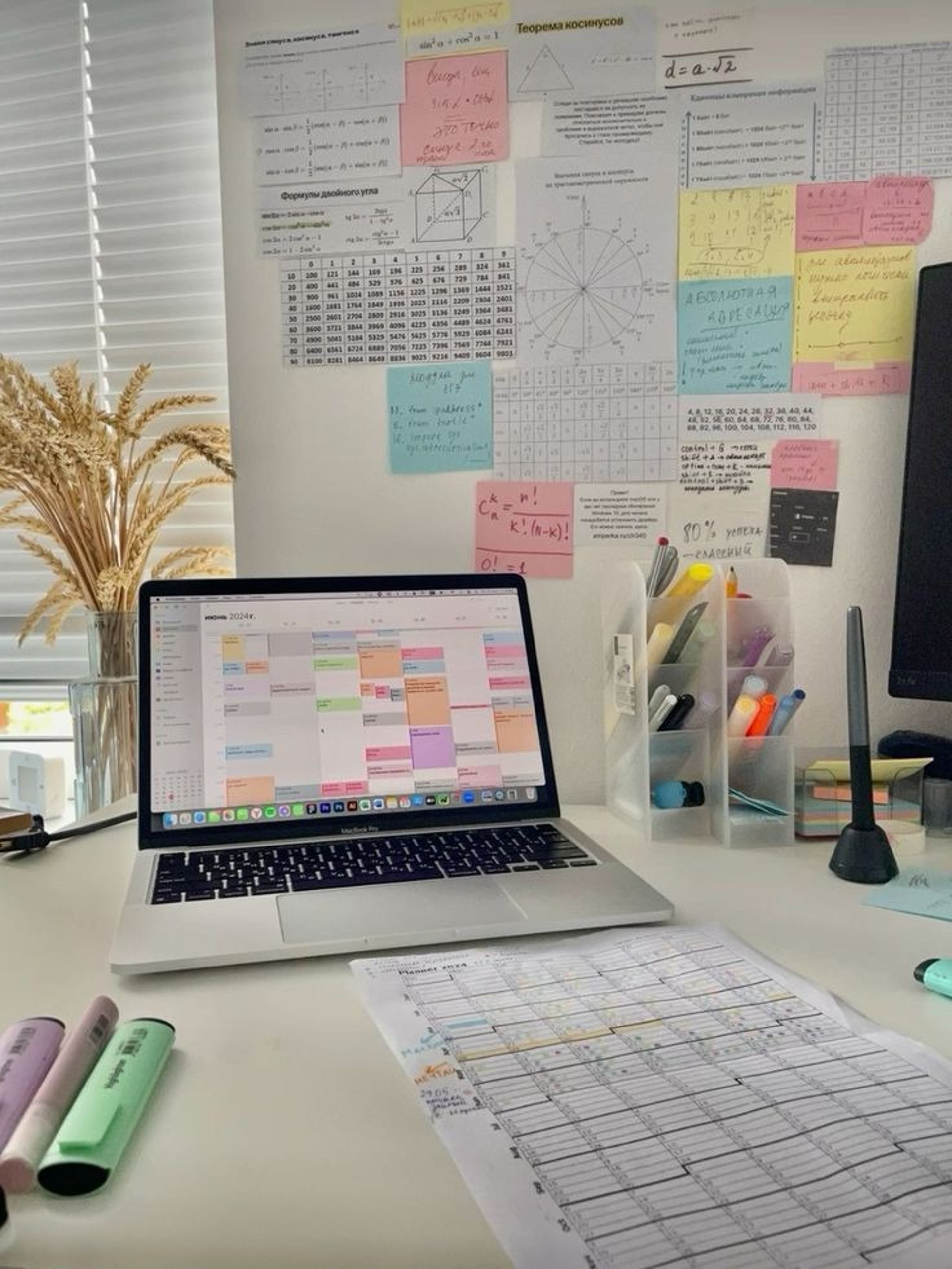 a laptop computer sitting on top of a white desk