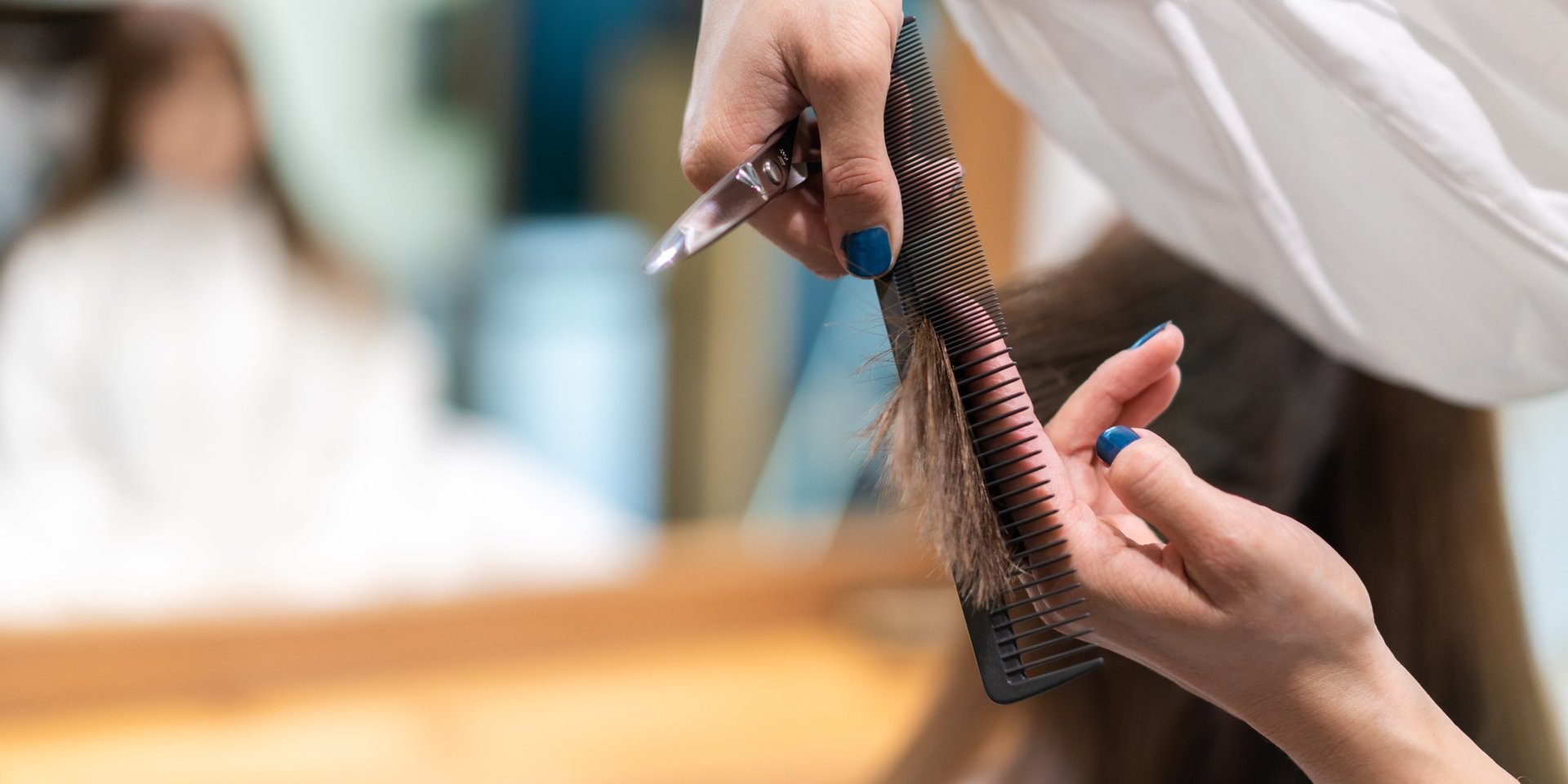 person holding silver and black hair brush