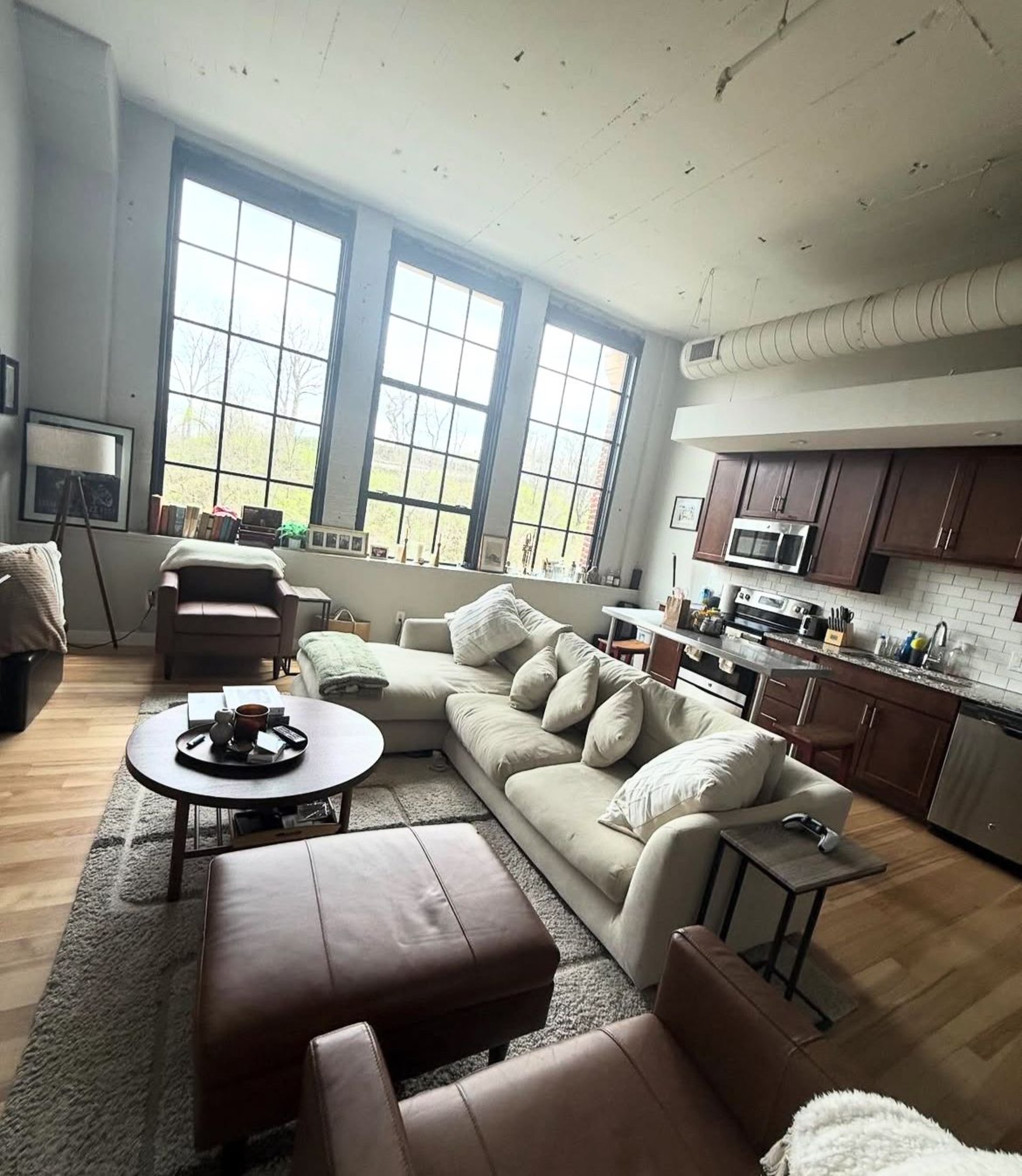 a living room filled with furniture and a large window