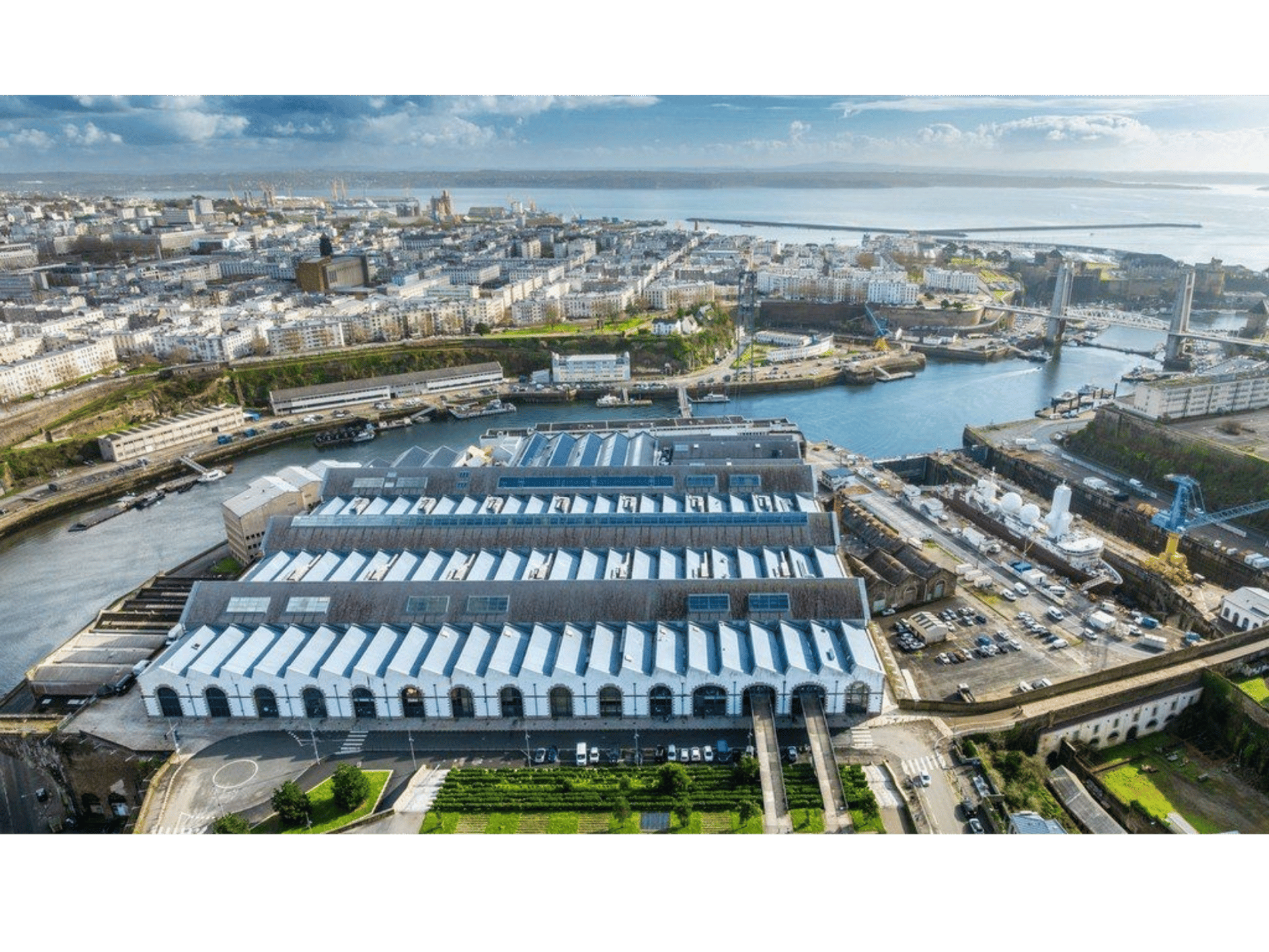 an abstract photo of a curved building with a blue sky in the background