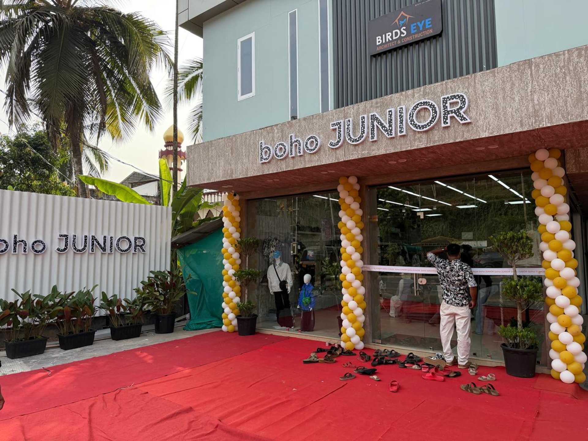 Woman giving a child a piggyback ride in a store.
