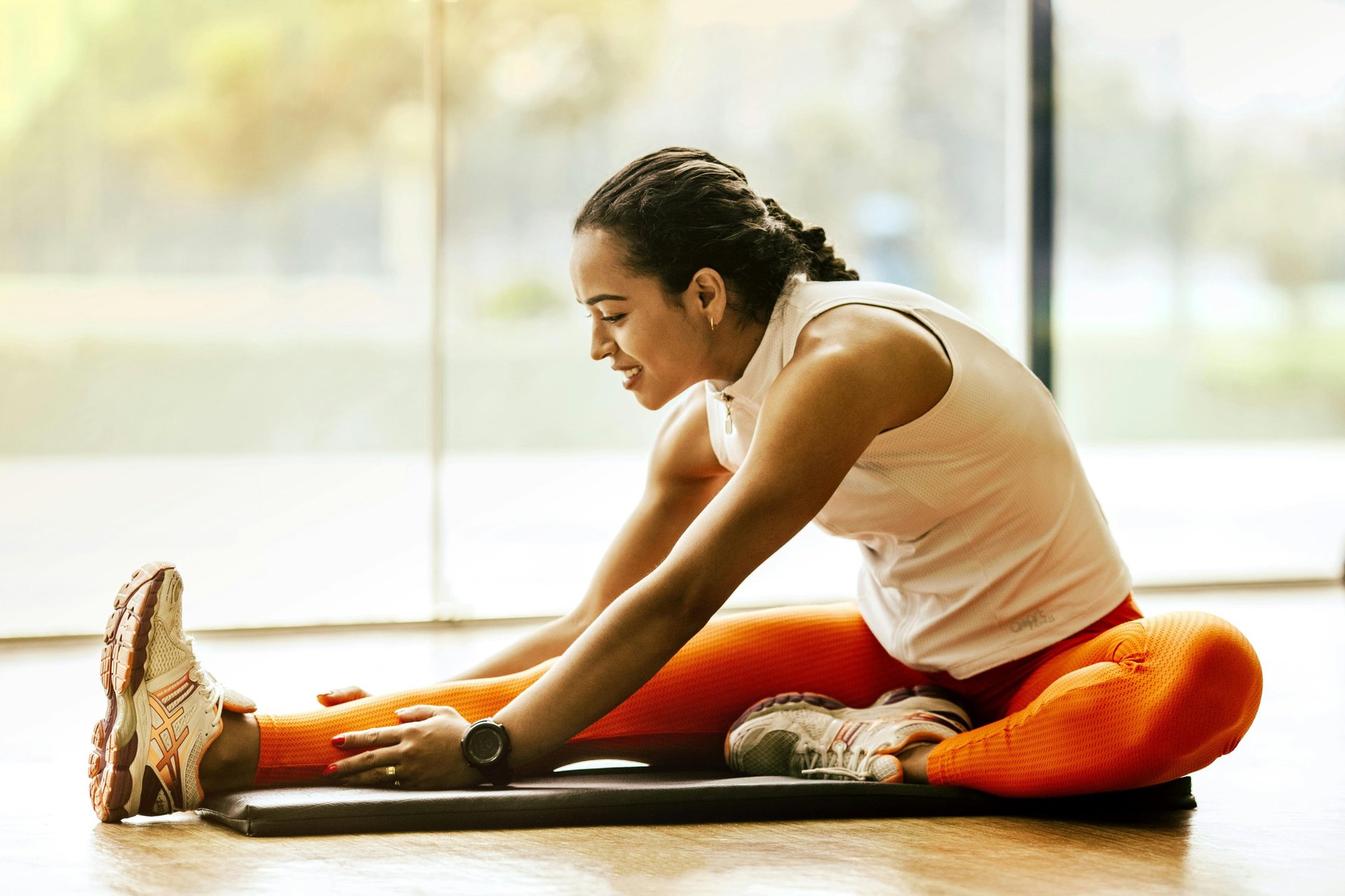 a woman with tattoos holding a kettle in a gym
