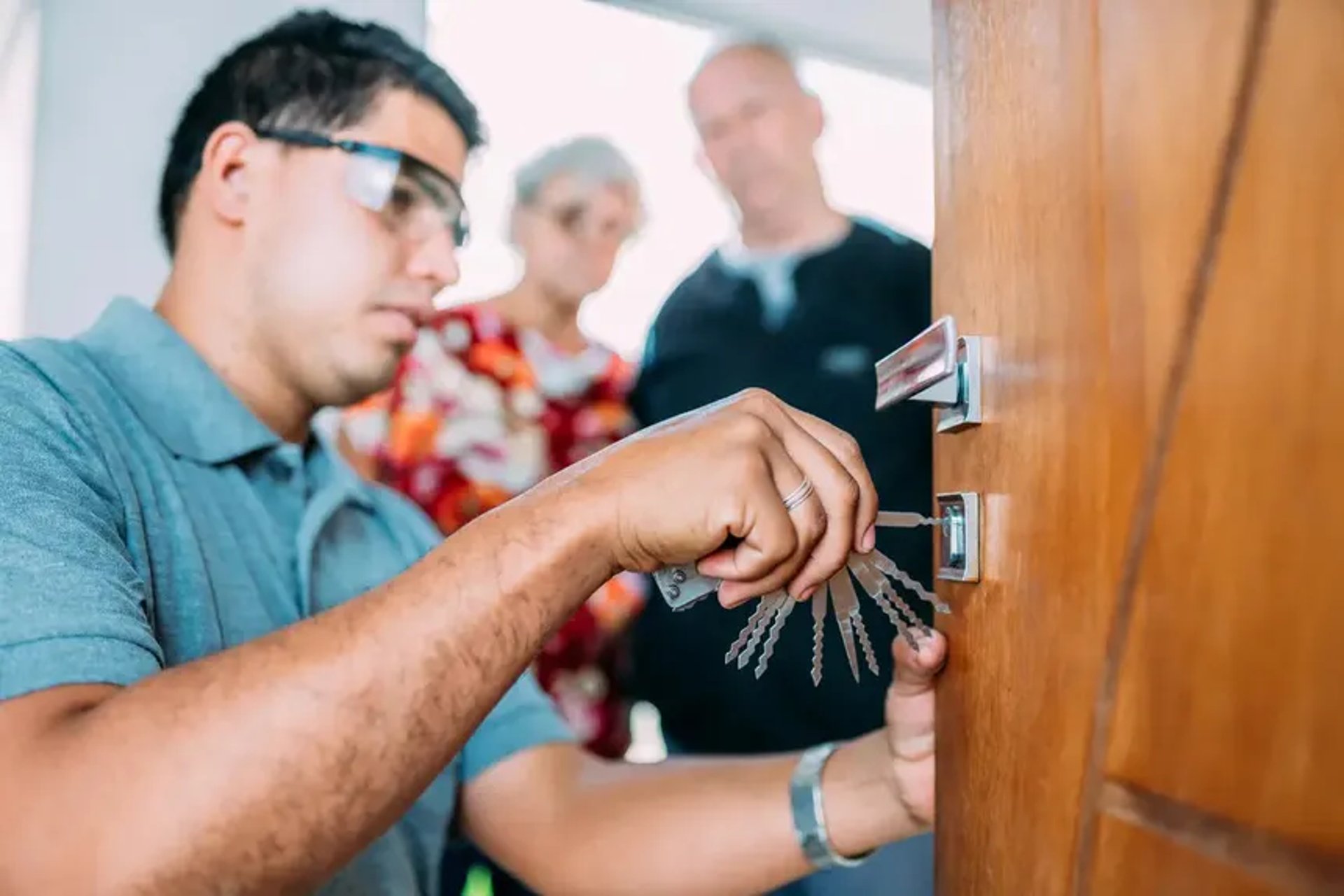 man wearing black pullover hoodie holding tool