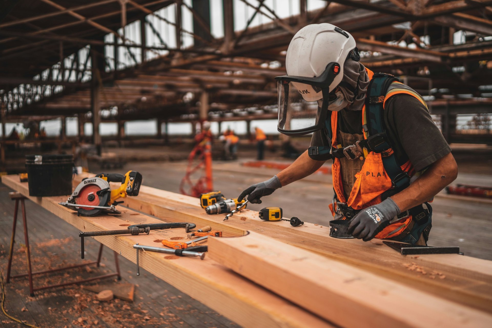 a man with a driller and a hat on