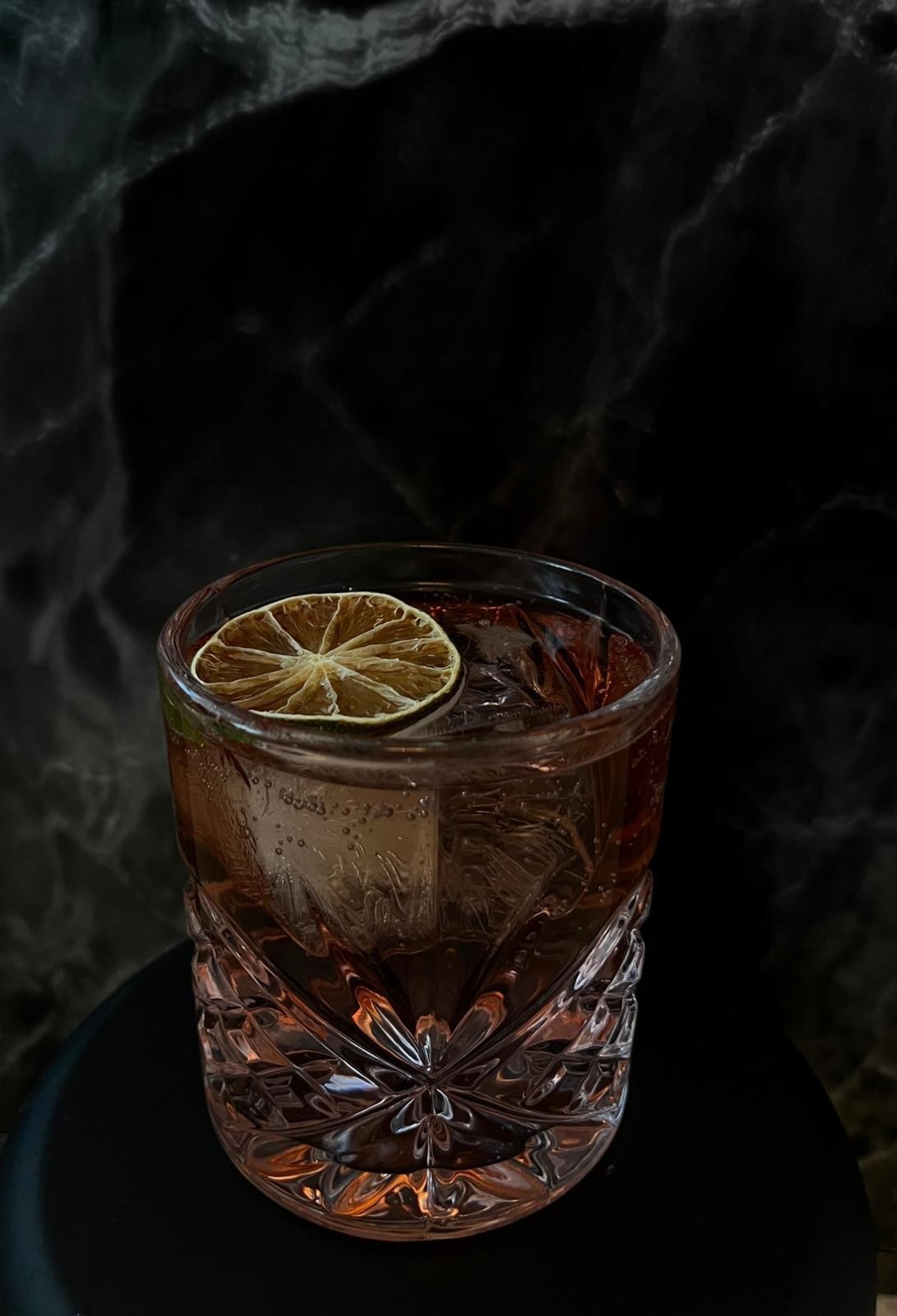 Creamy cocktail with flowers and cinnamon stick garnish