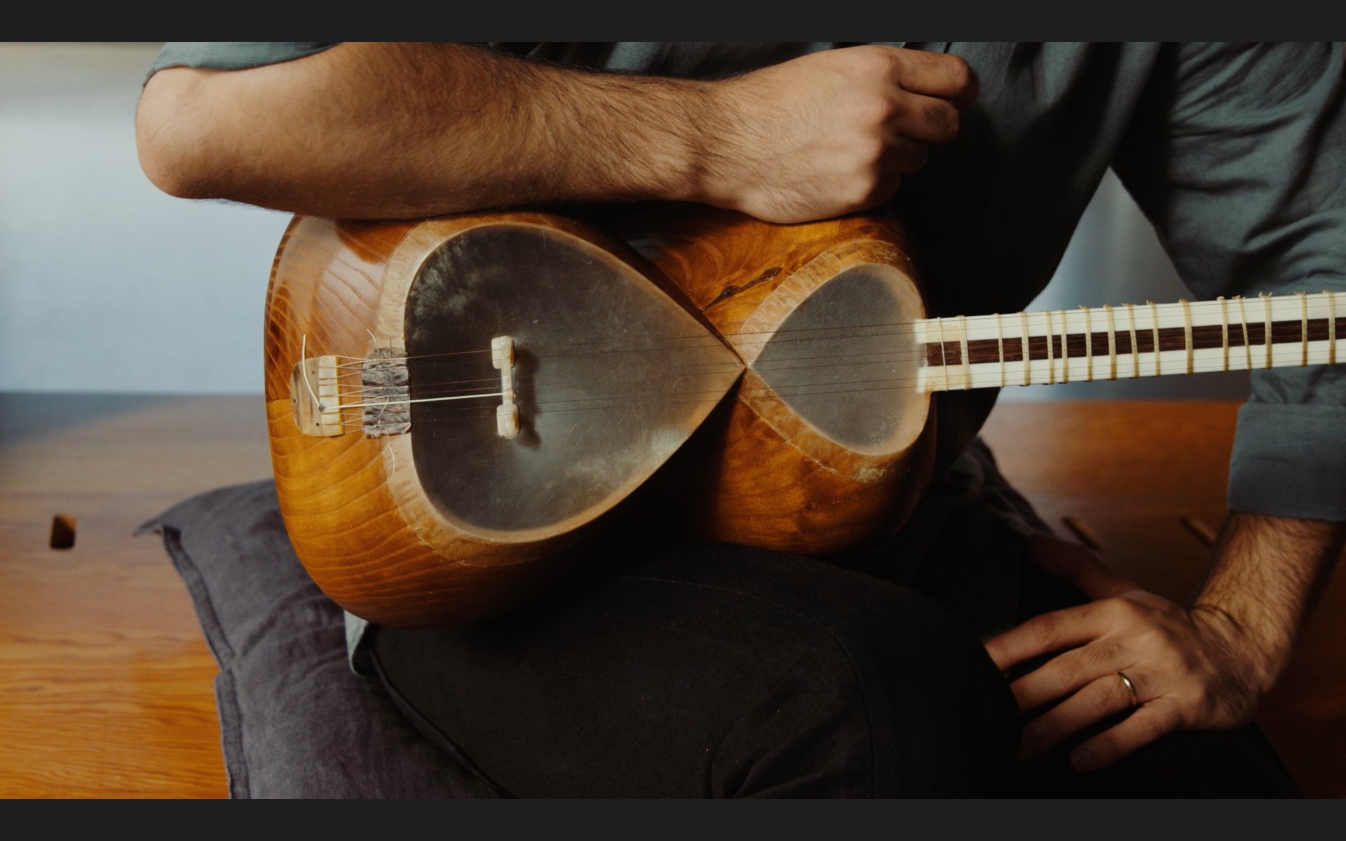an abstract photo of a curved building with a blue sky in the background