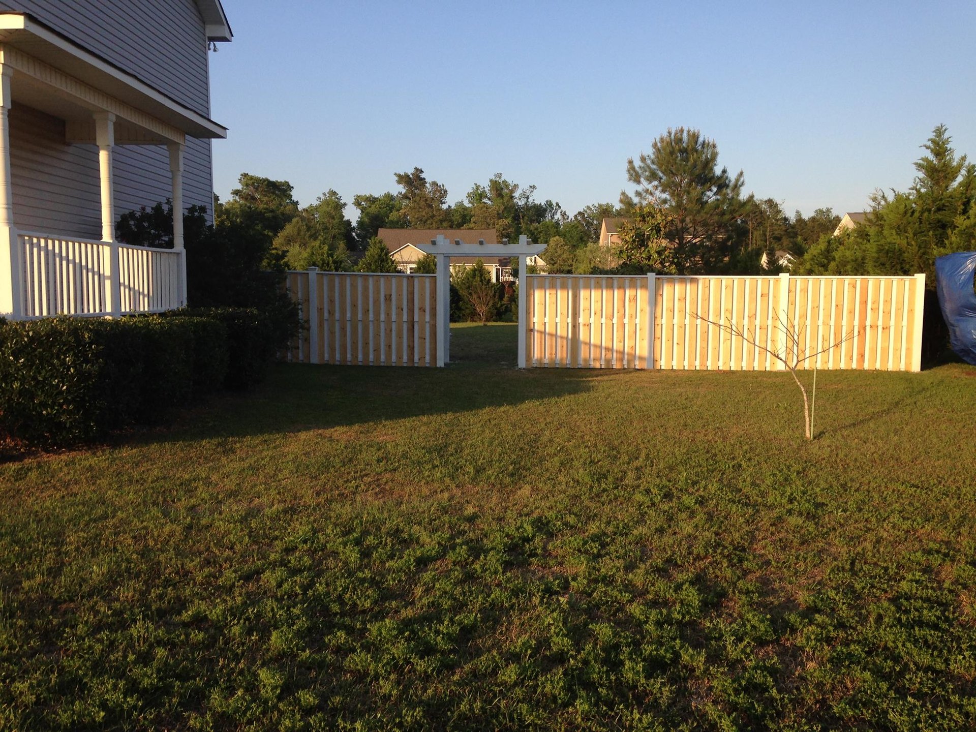 a couple of men working on a wooden structure