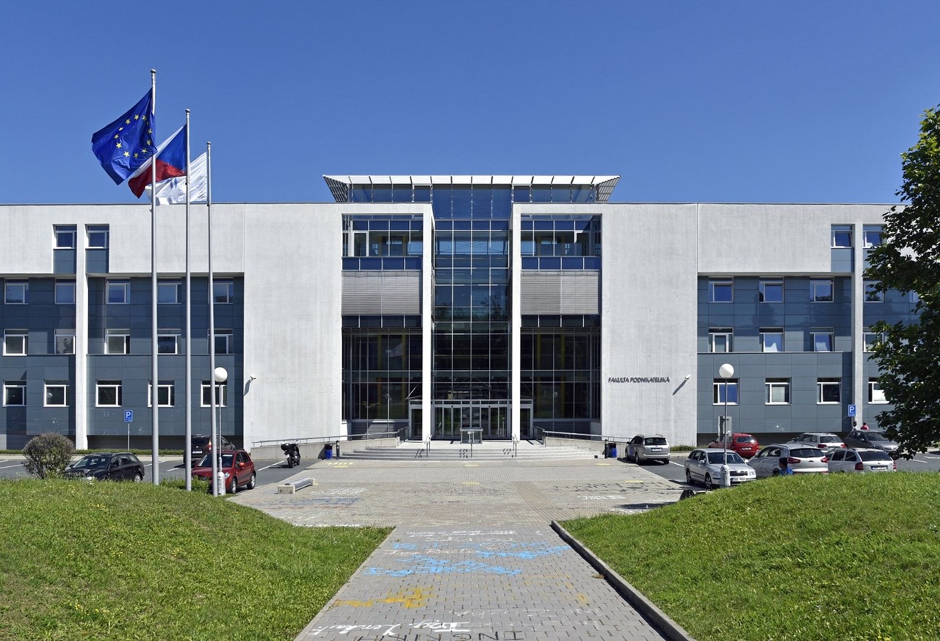 woman wearing black crew-neck dress walking near the chair