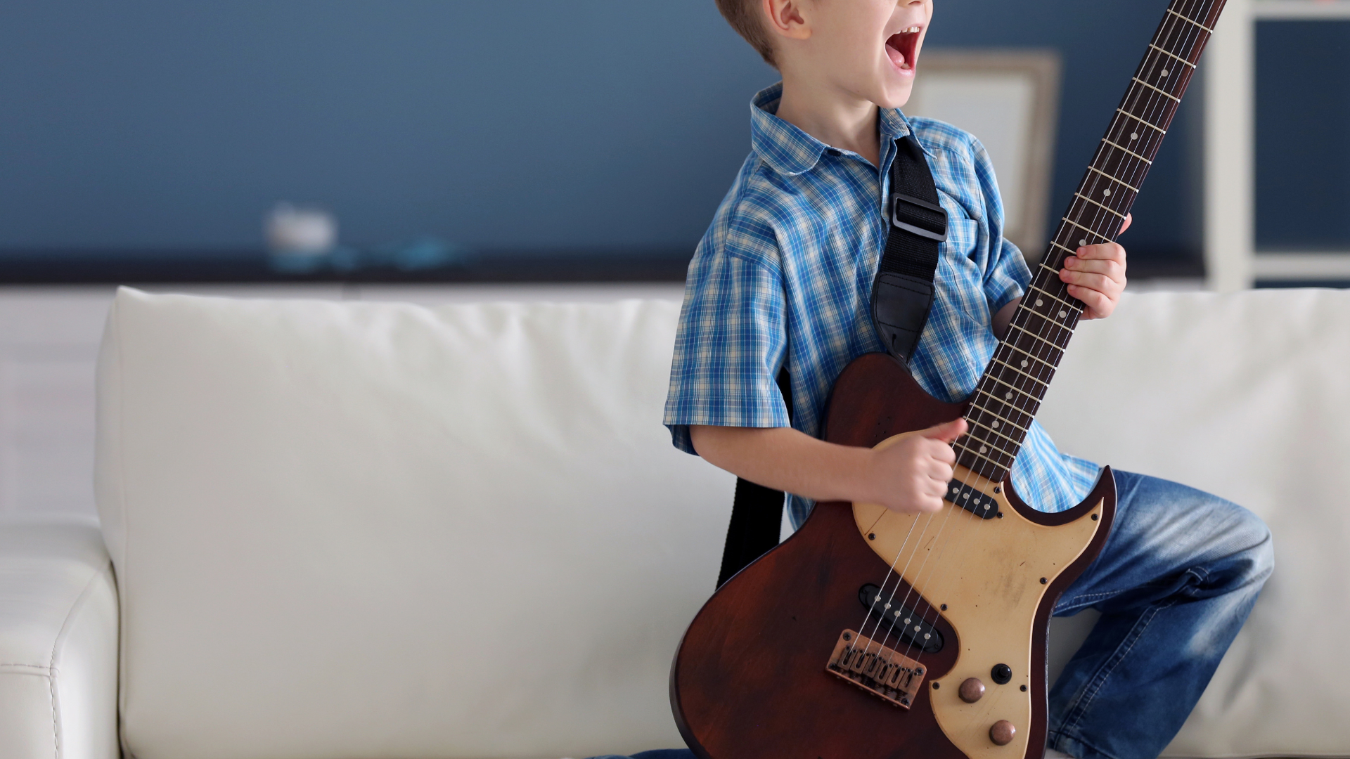 A close up of a bass guitar in a dark room
