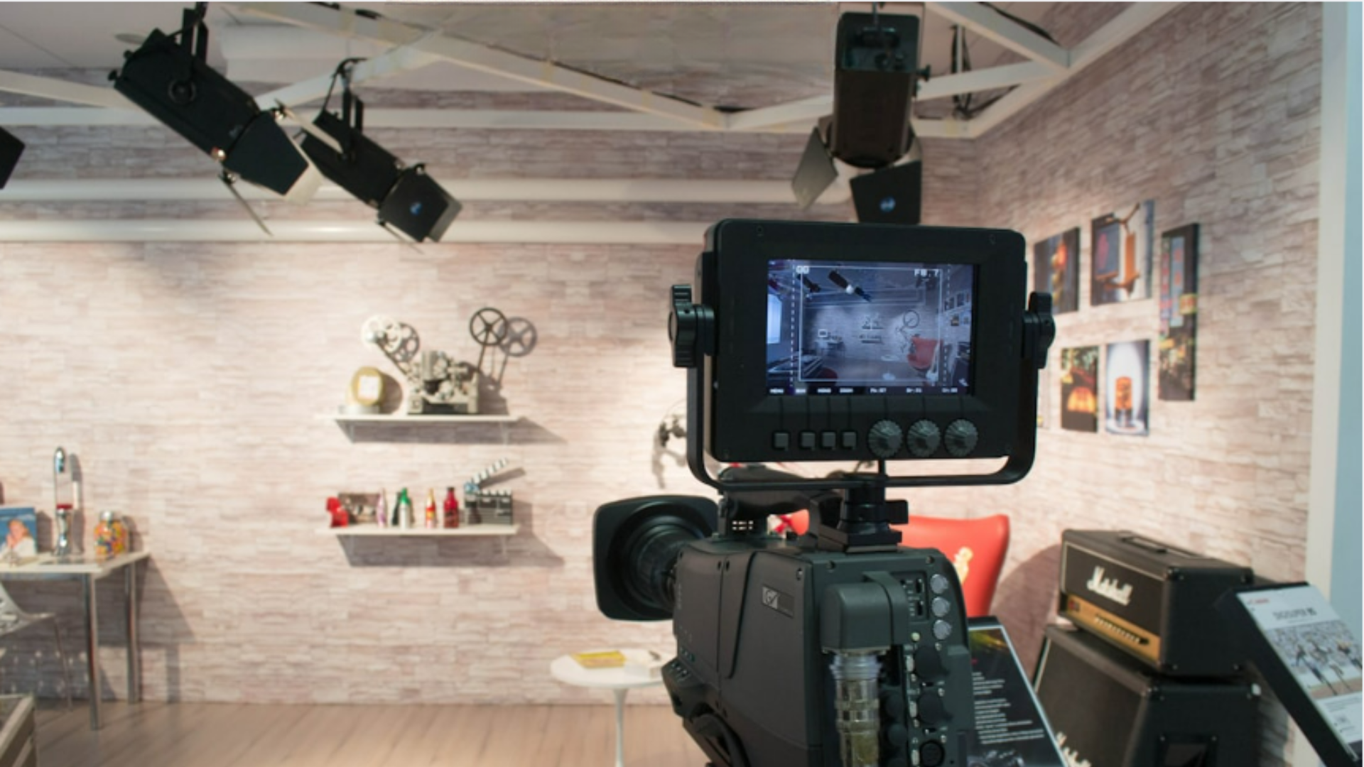A camera set up in front of a television in a room