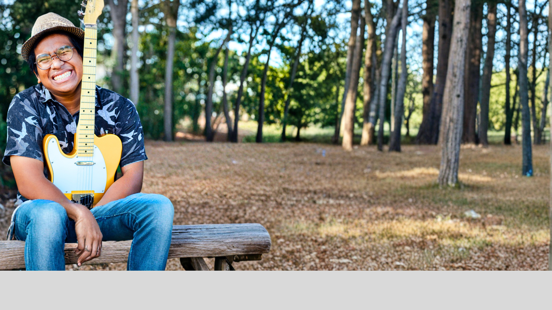 A close up of a bass guitar in a dark room