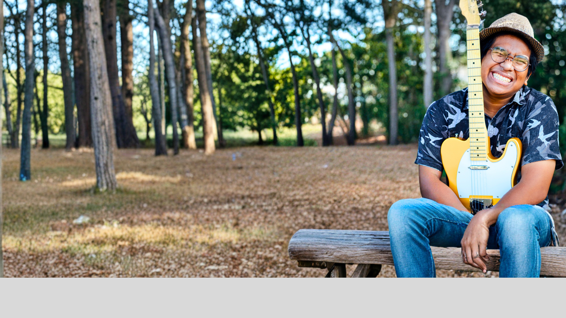 A close up of a bass guitar in a dark room