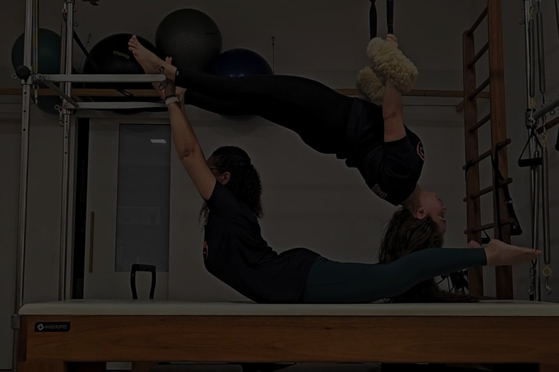 woman in black tank top and black leggings doing yoga
