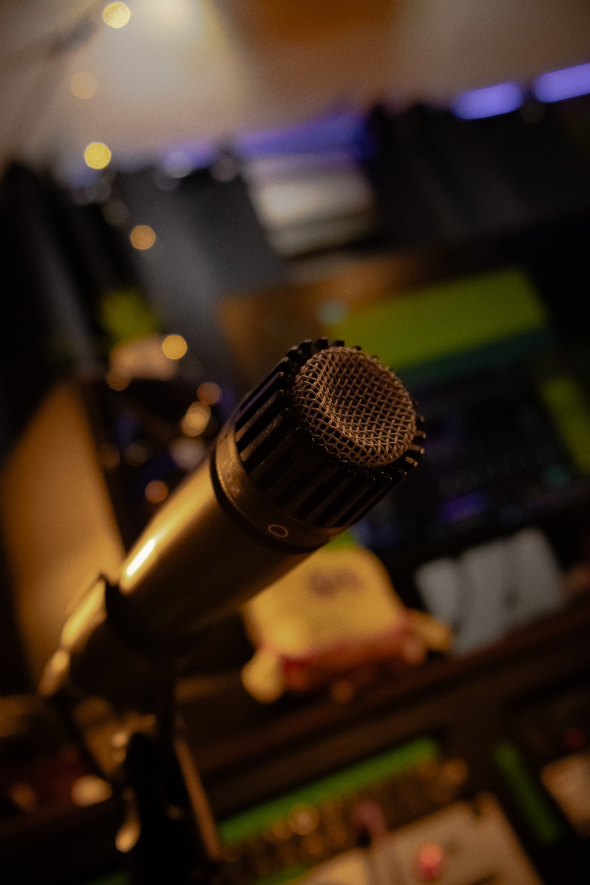 flat-lay photo of headphones, MIDI keyboard, and speaker on black surface