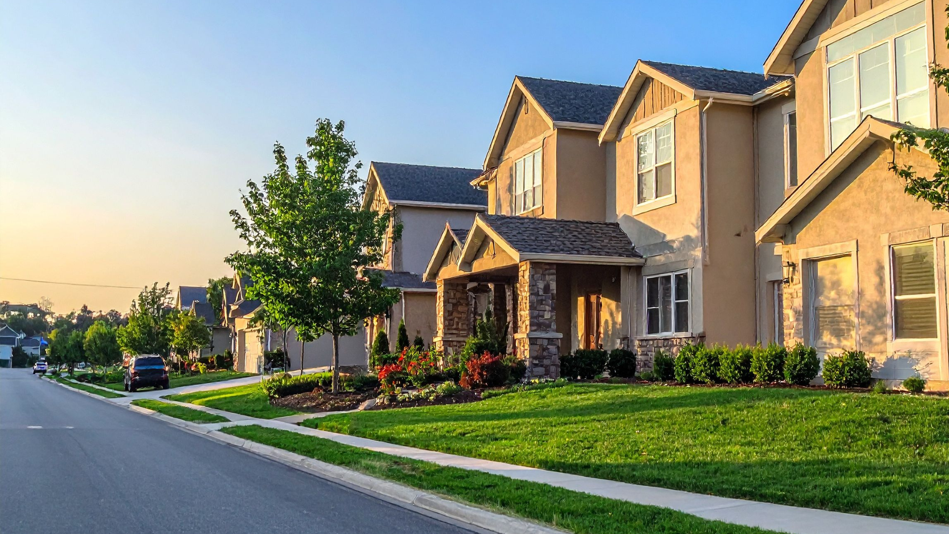 brown and white concrete house near green trees during daytime