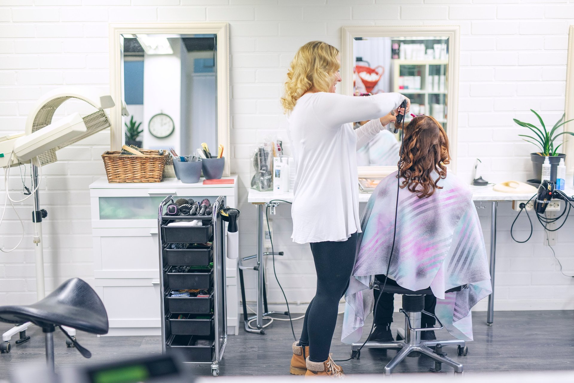 woman in black long sleeve shirt sitting on beige chair