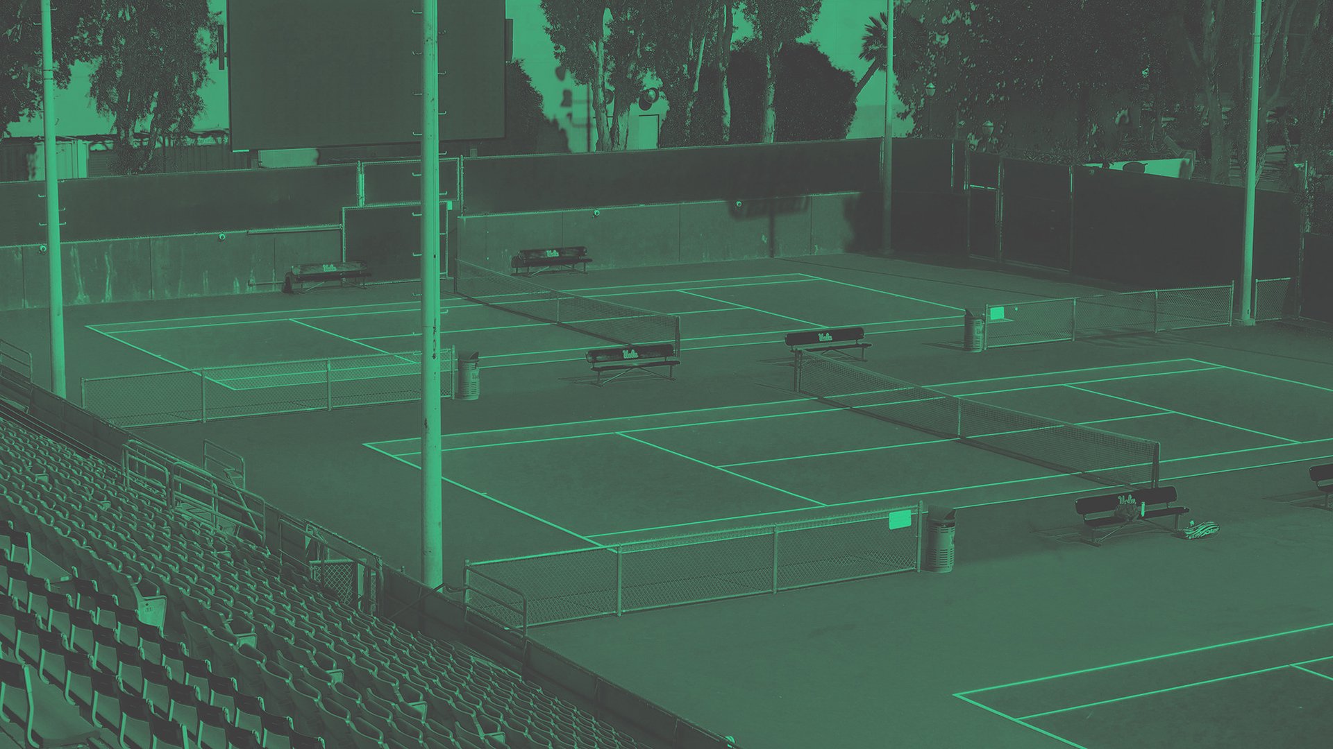 a tennis racket and four tennis balls on a court