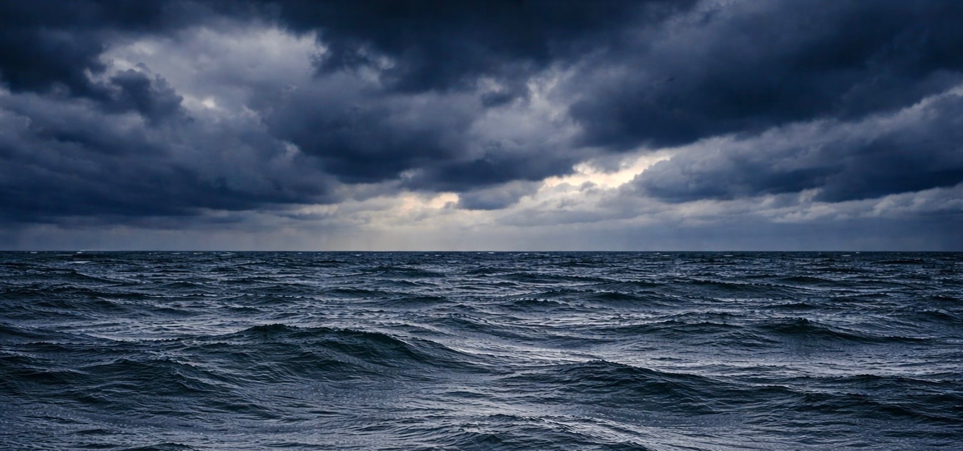 an abstract photo of a curved building with a blue sky in the background