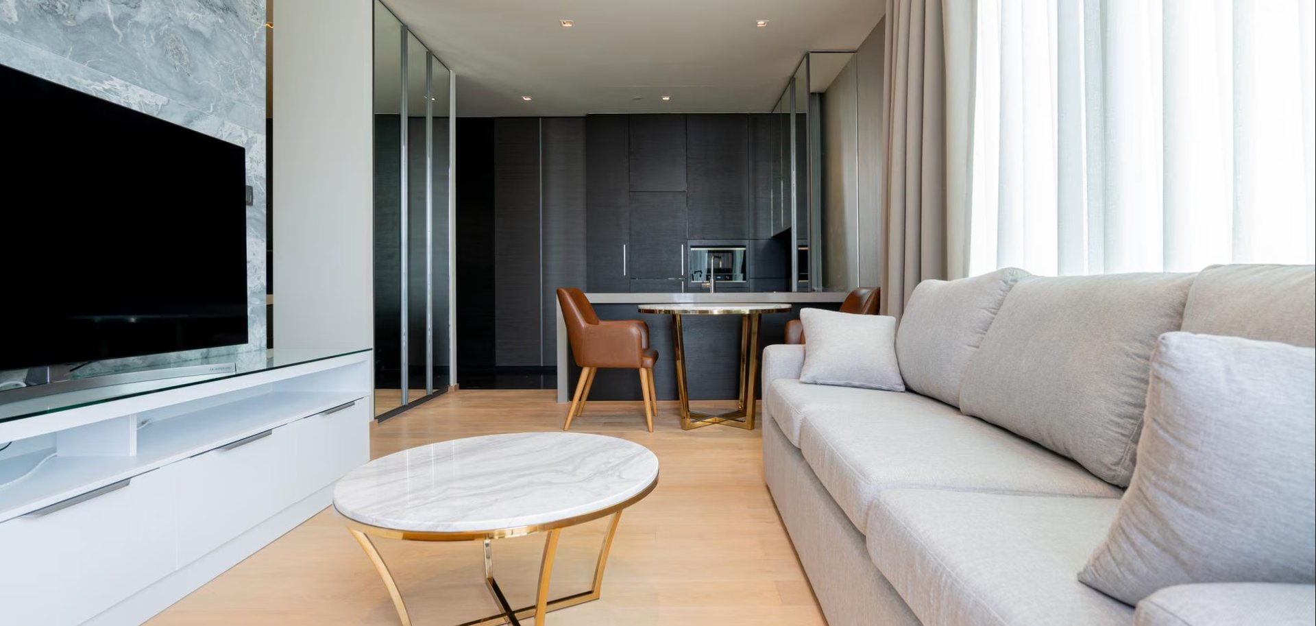 a living room filled with furniture and a flat screen tv