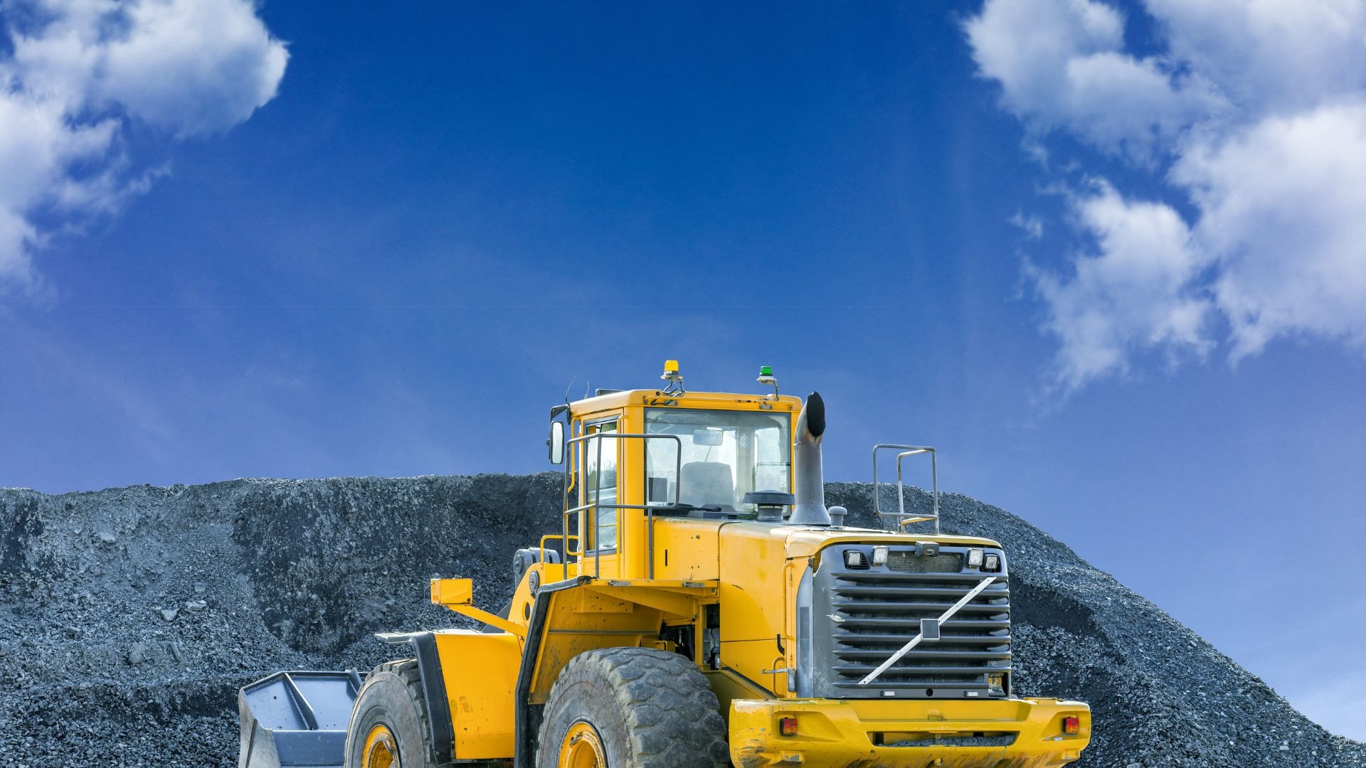 an abstract photo of a curved building with a blue sky in the background