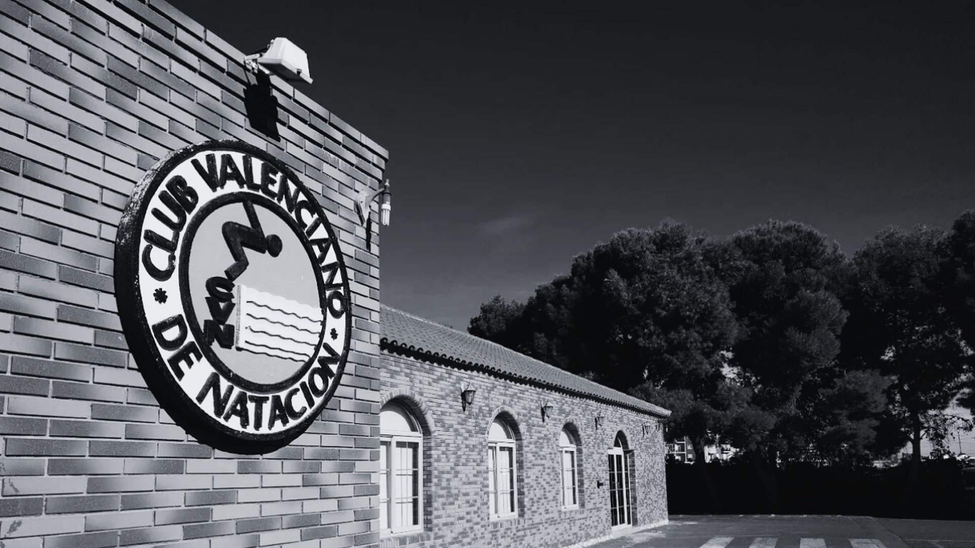 an abstract photo of a curved building with a blue sky in the background