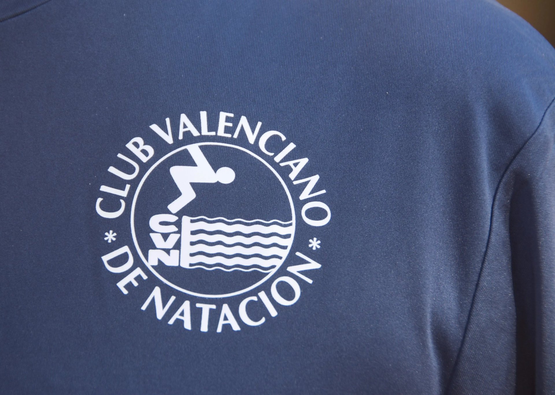 an abstract photo of a curved building with a blue sky in the background