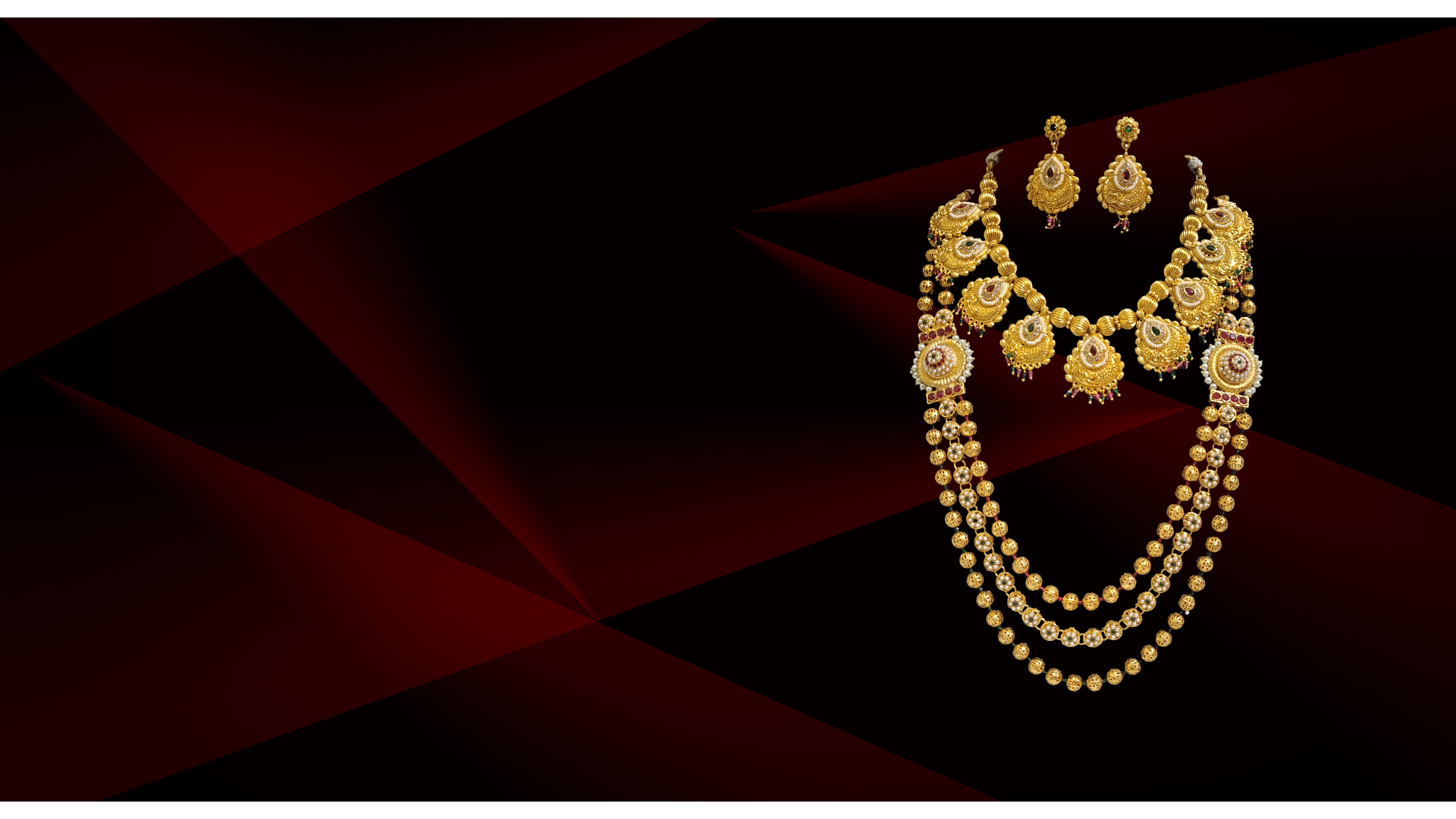 A stack of ornate gold bangles on a dark surface.