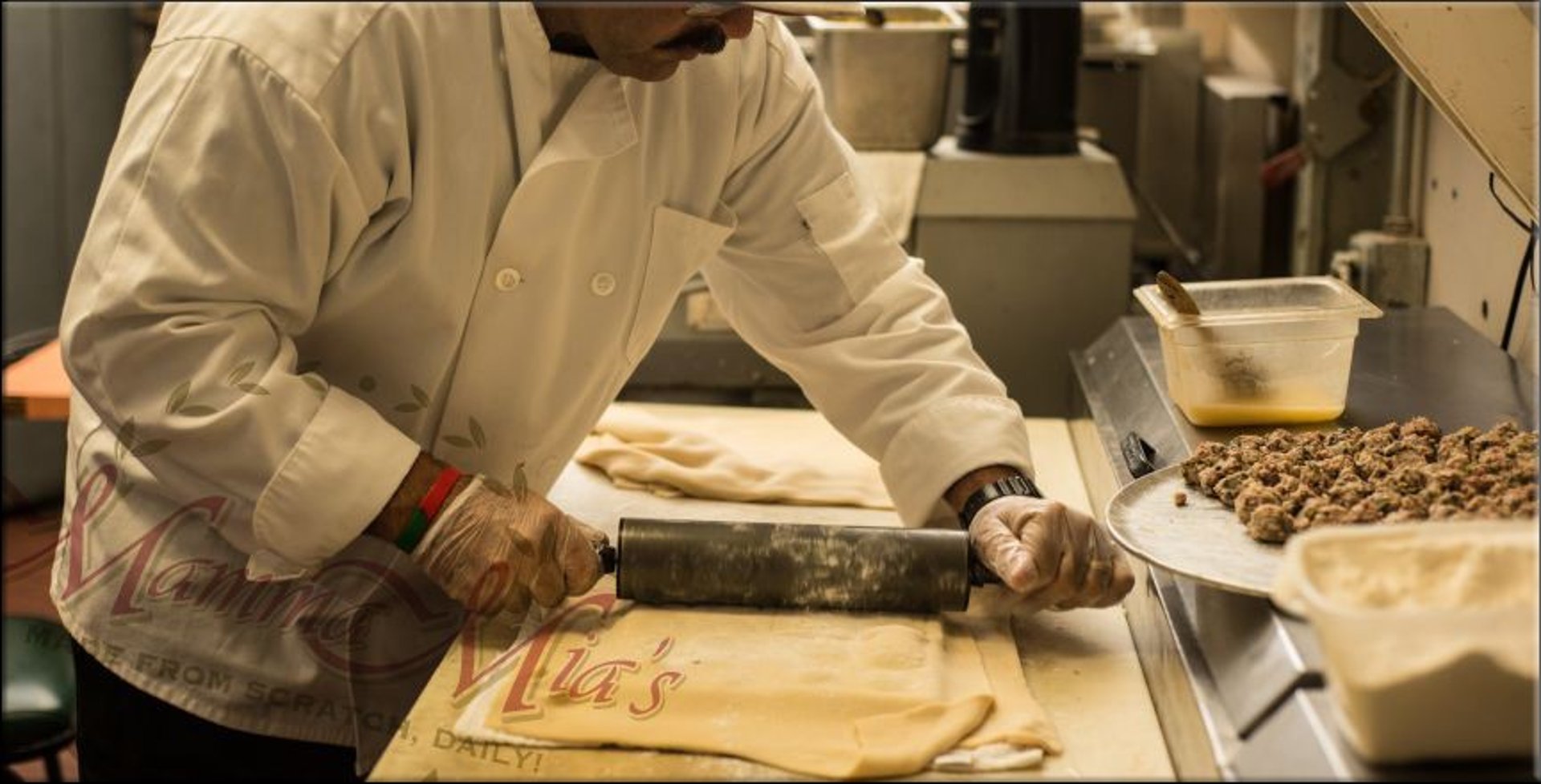 a person holding a slice of lemon over a plate of food