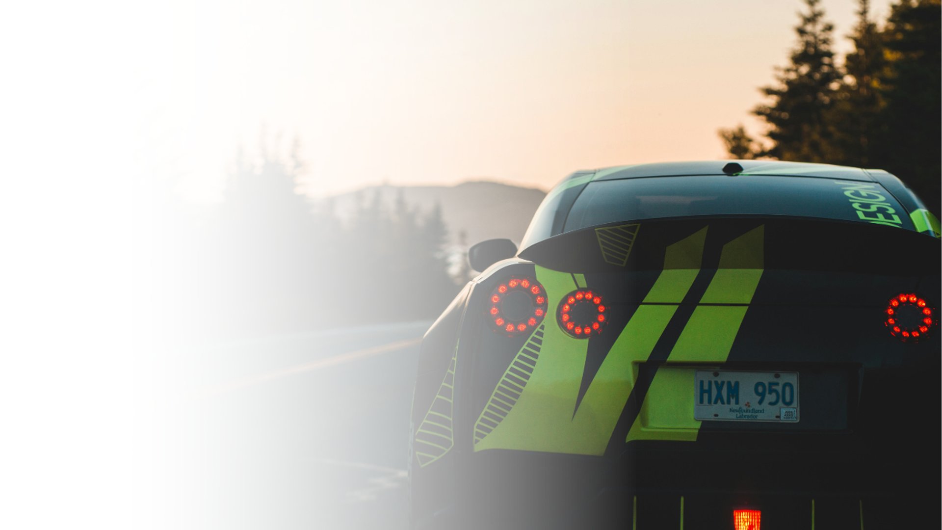A bright green sports car on a race track.