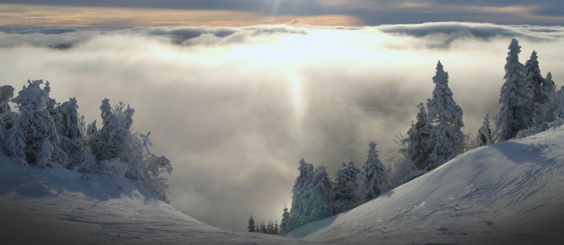 a snow covered mountain with a ski lift on top of it