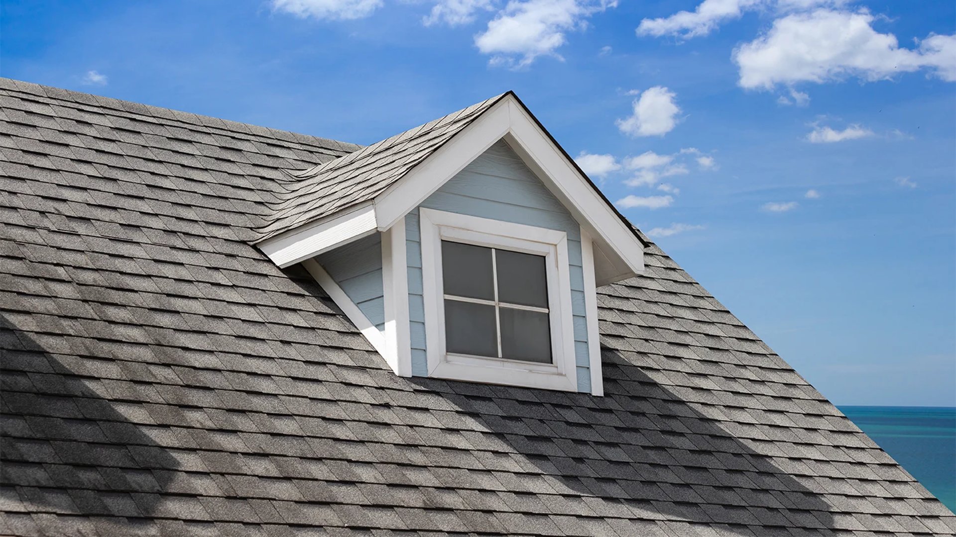 an abstract photo of a curved building with a blue sky in the background