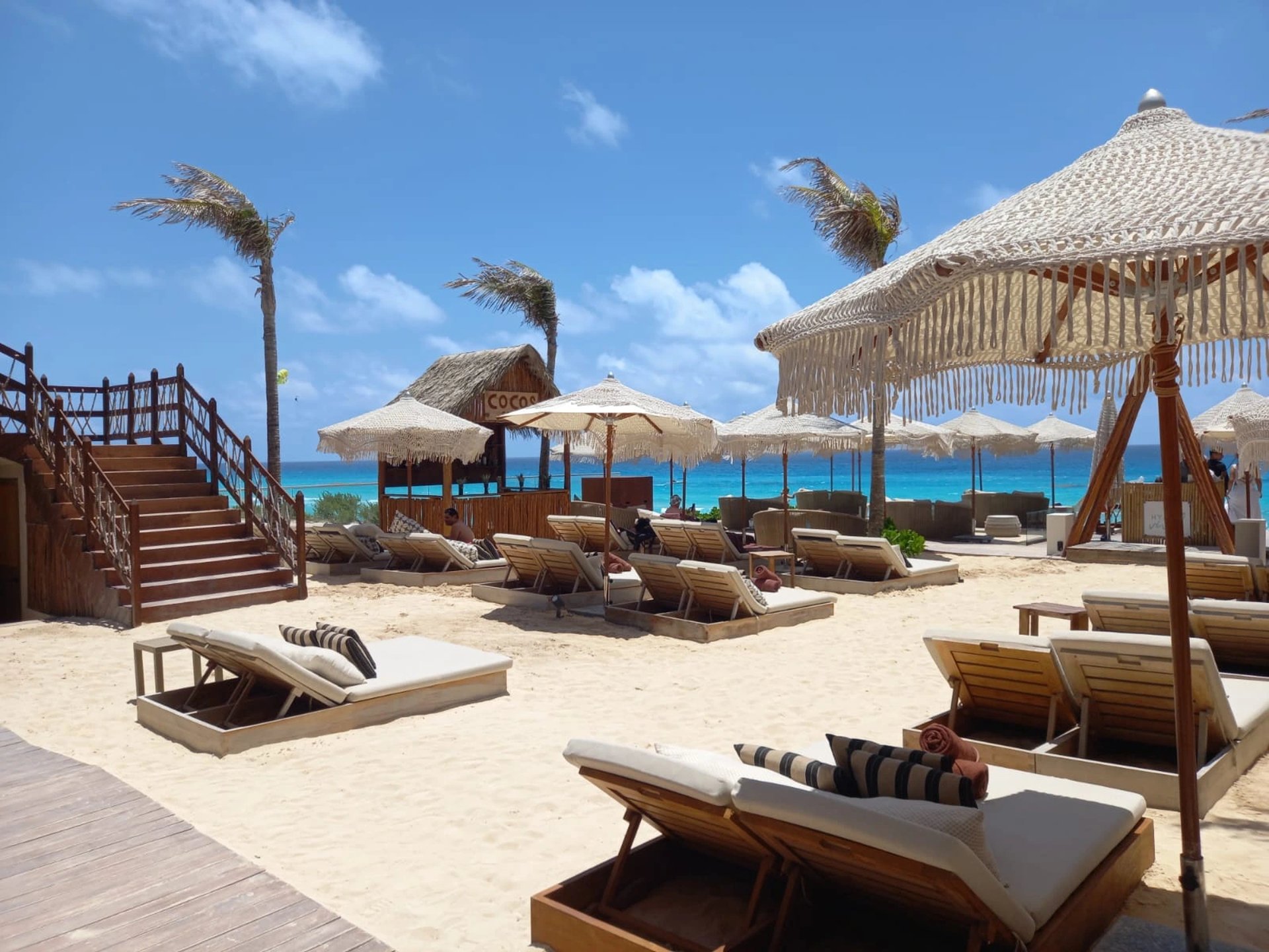 an abstract photo of a curved building with a blue sky in the background