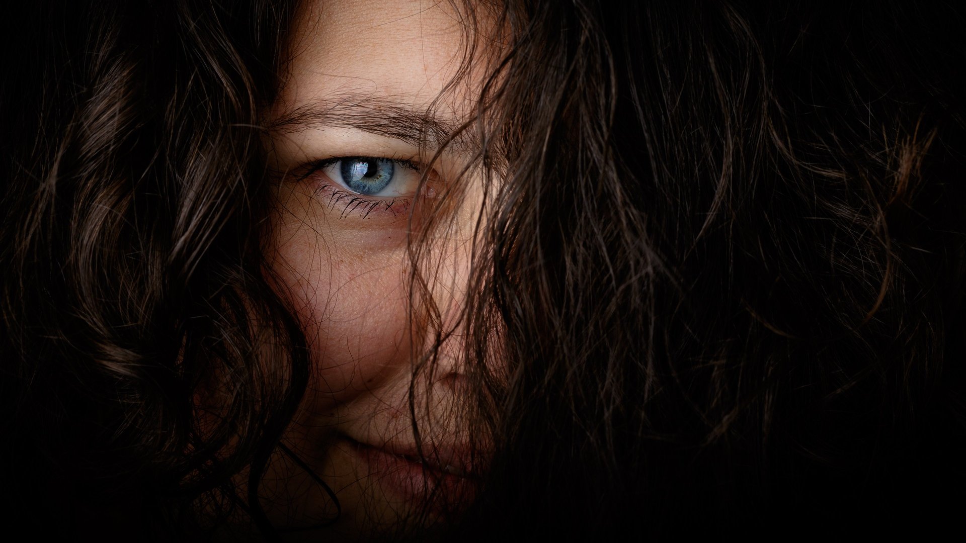 an abstract photo of a curved building with a blue sky in the background