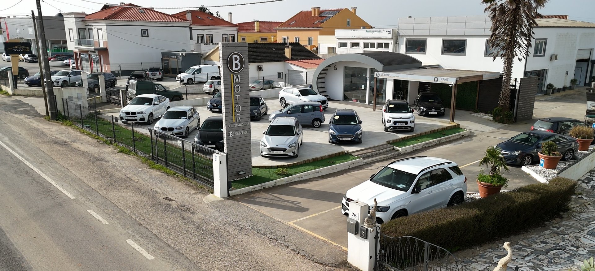 a man in a suit standing next to a car