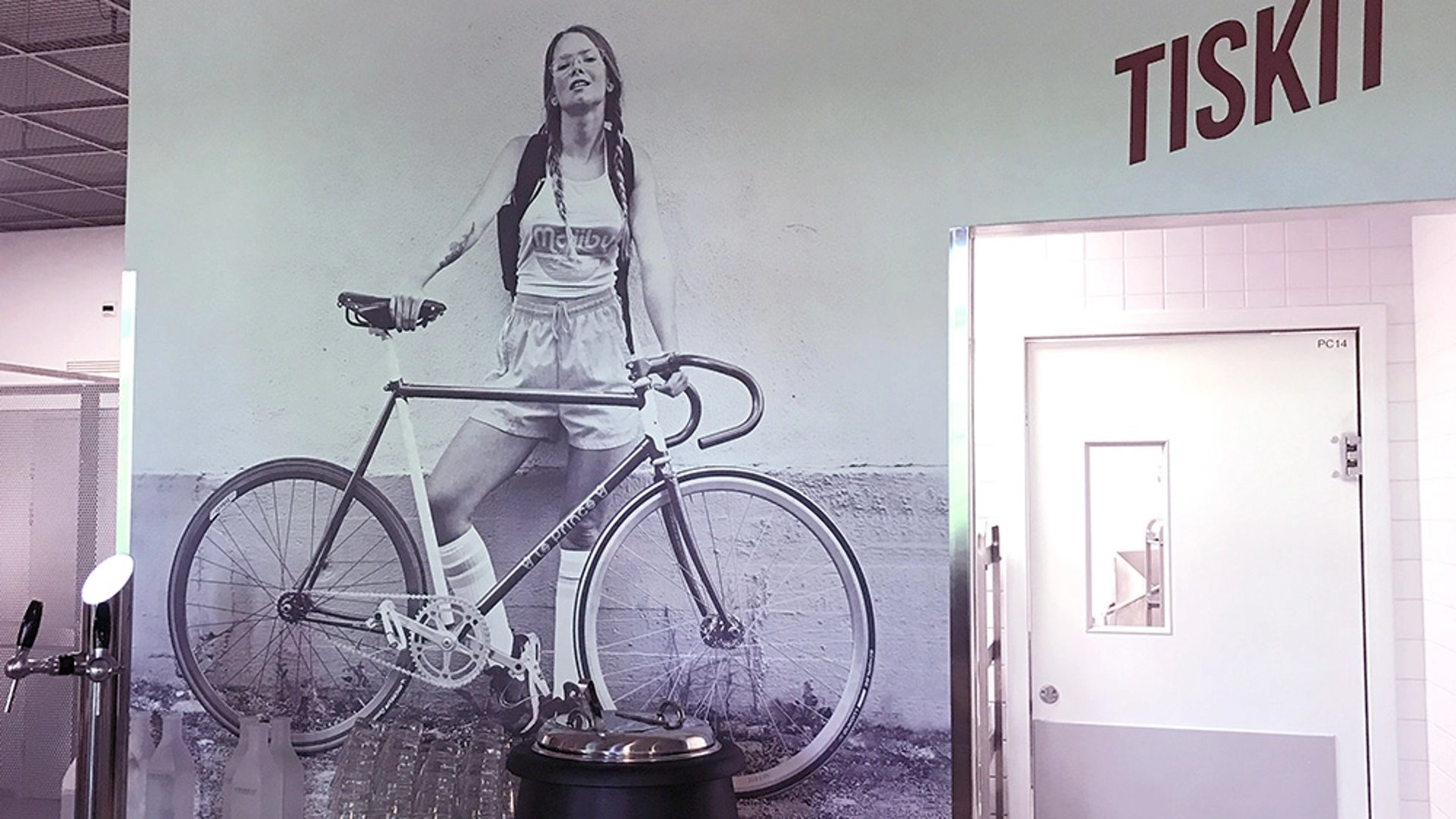 wall mural in a cafe of a girl and her bike printed with a UV in wall printer
