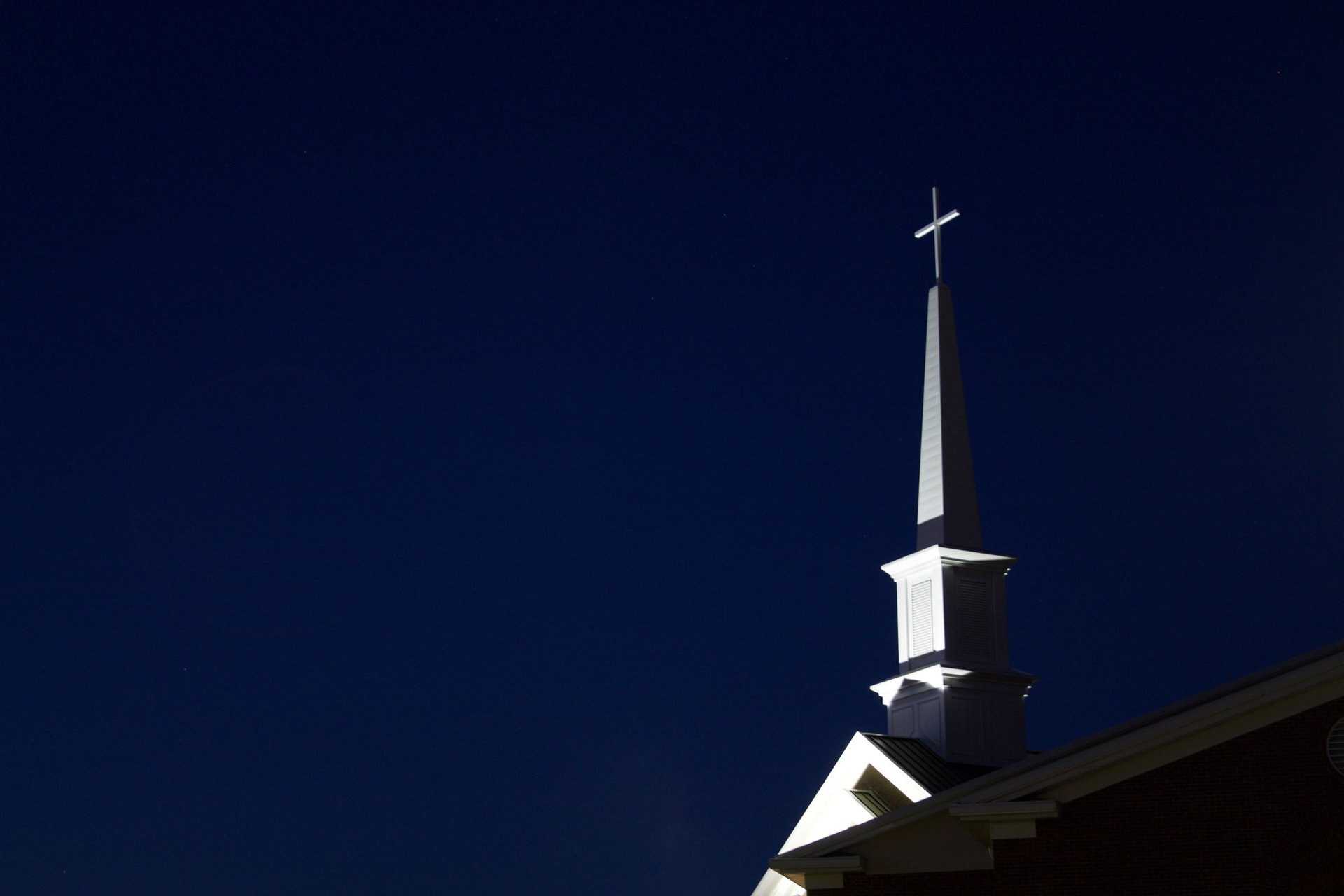 an abstract photo of a curved building with a blue sky in the background