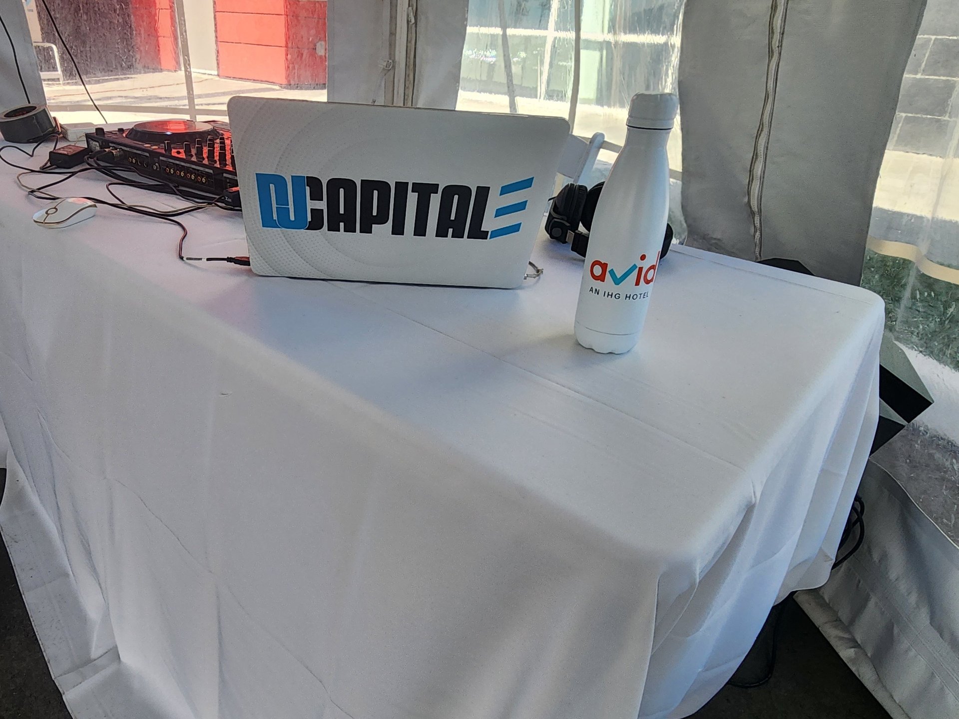 selective focus silhouette photography of man playing red-lighted DJ terminal