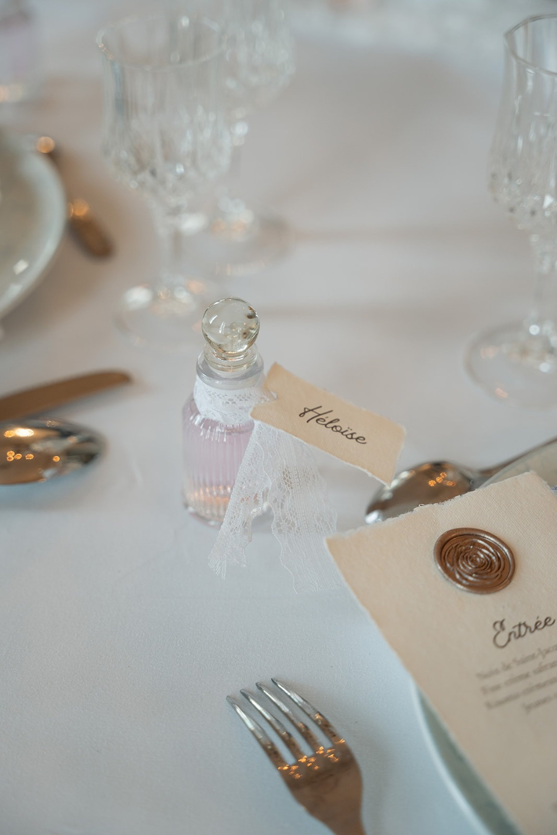 a table with a glass lantern and a candle on it