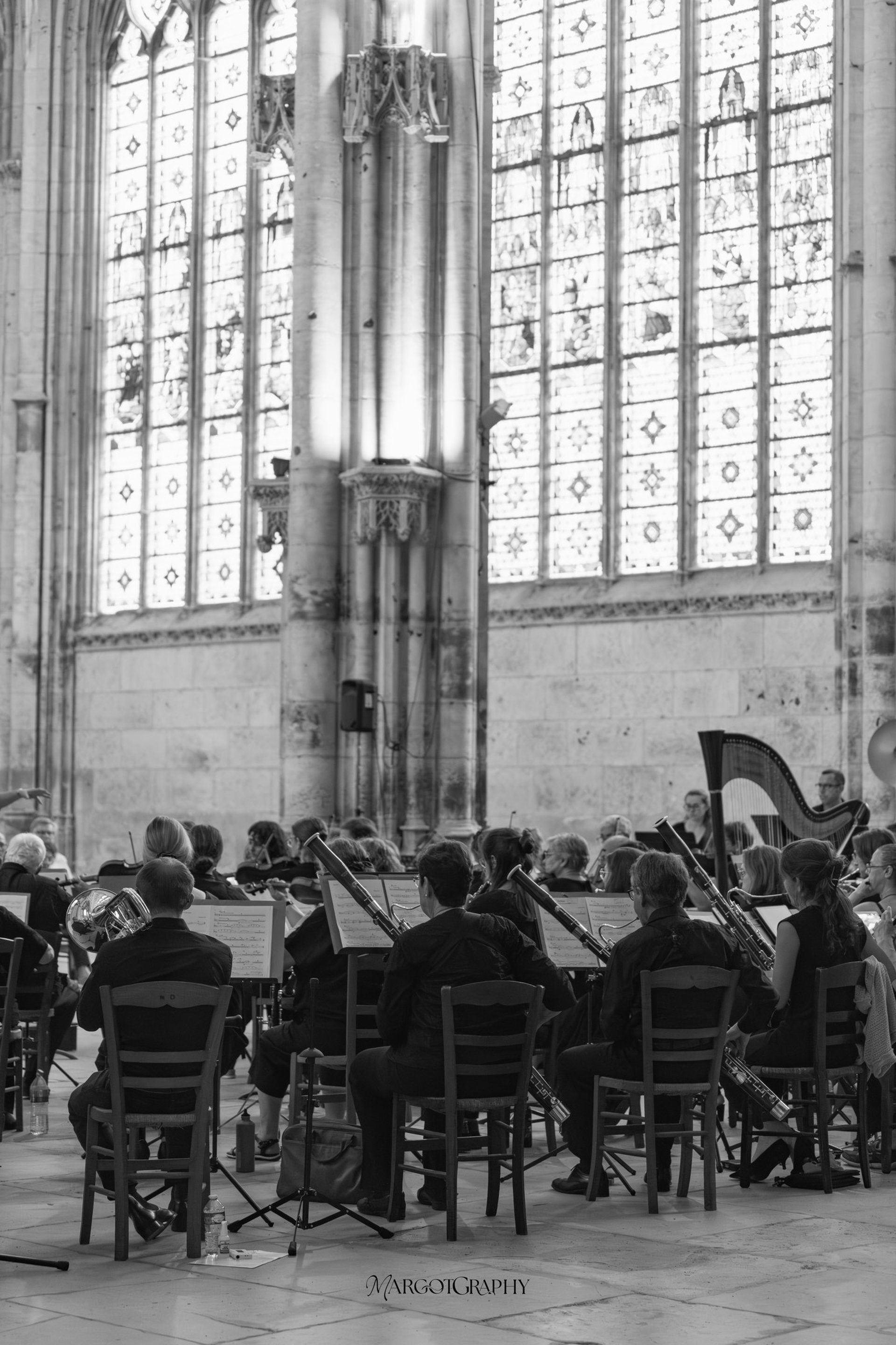 grayscale photography of orchestra playing on theatre