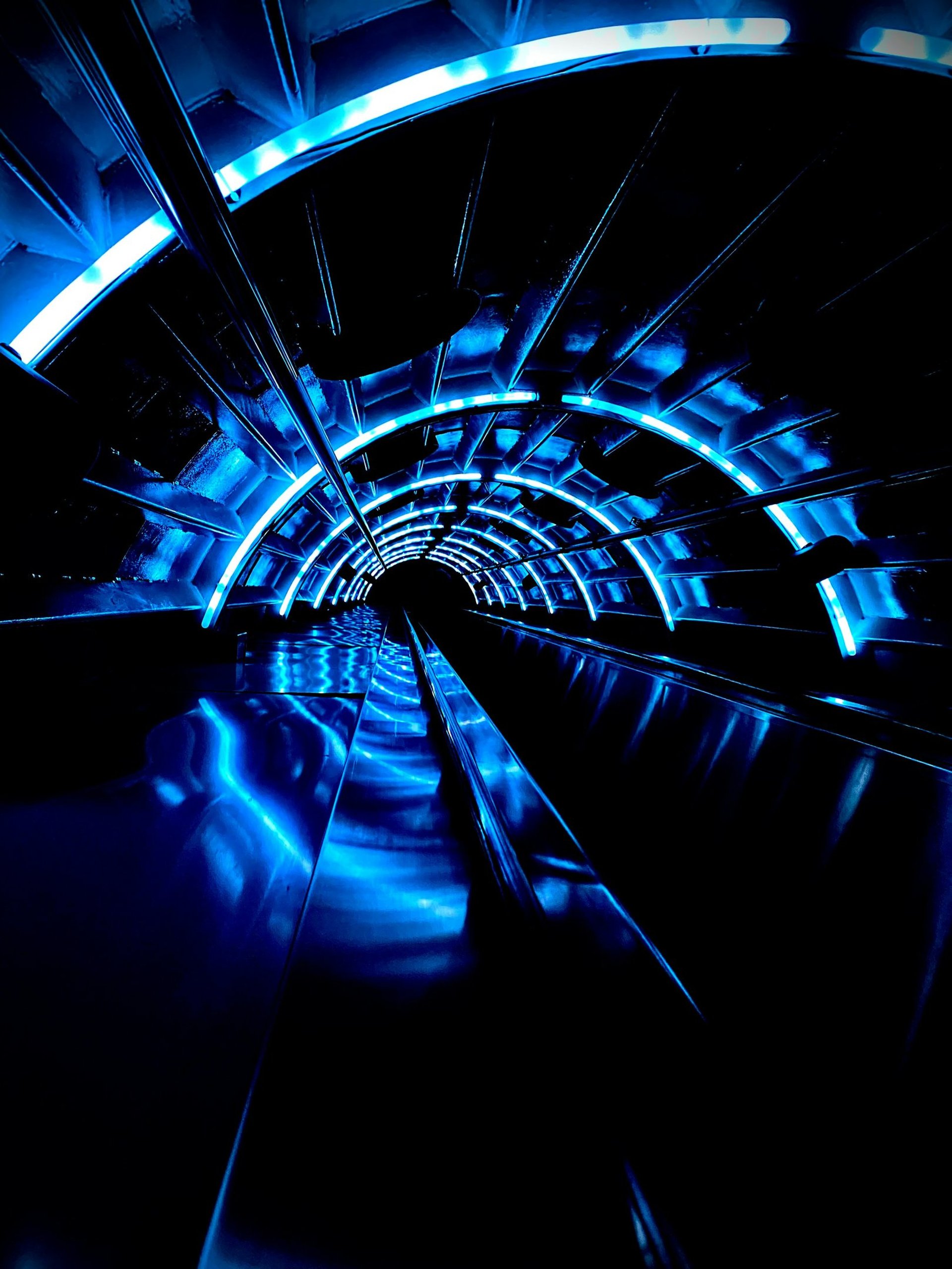 an abstract photo of a curved building with a blue sky in the background