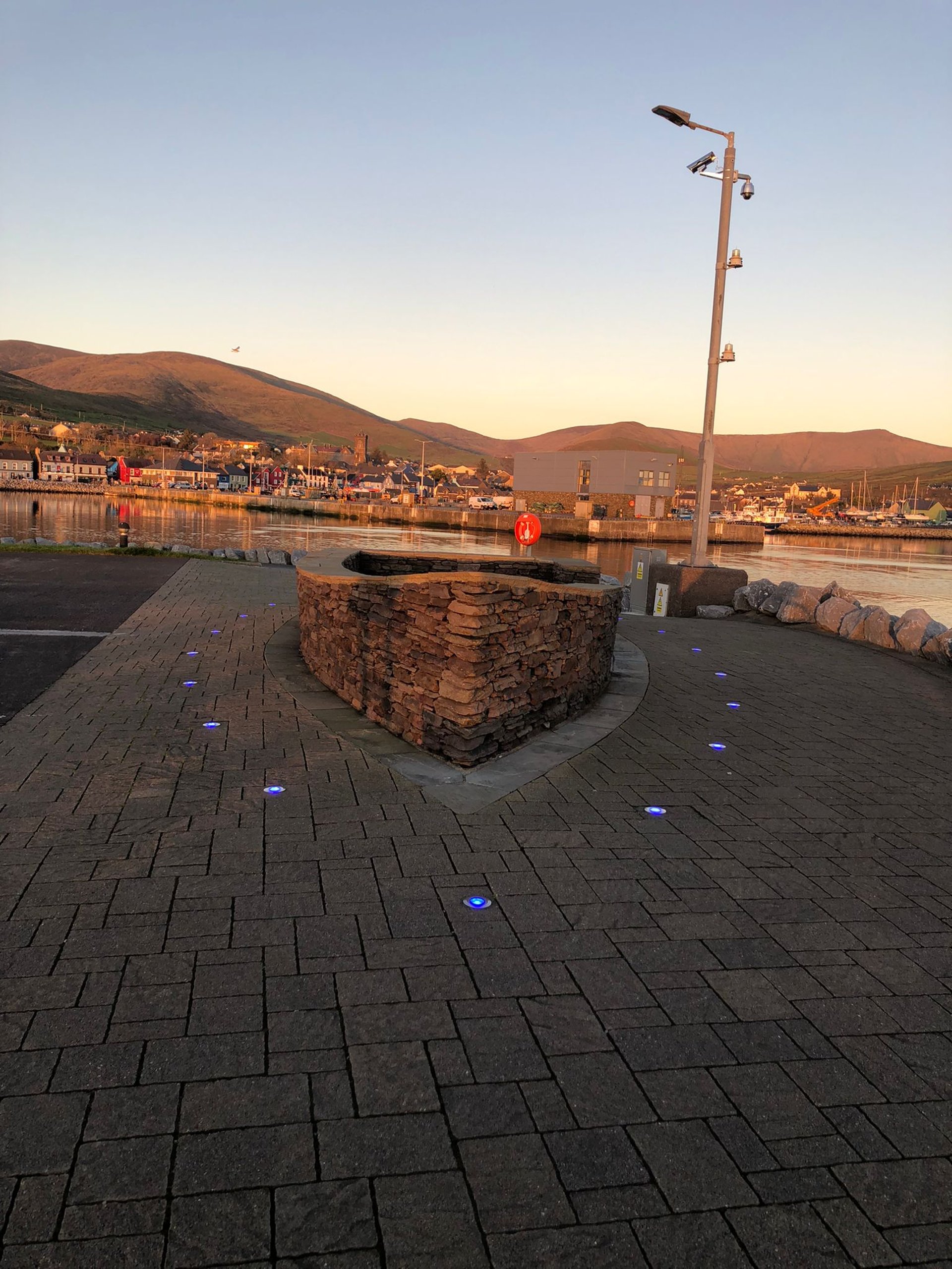 green grass field near body of water during daytime