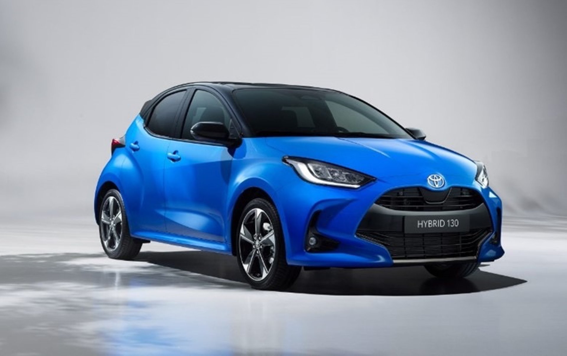 Person in car wearing a hat and glasses.