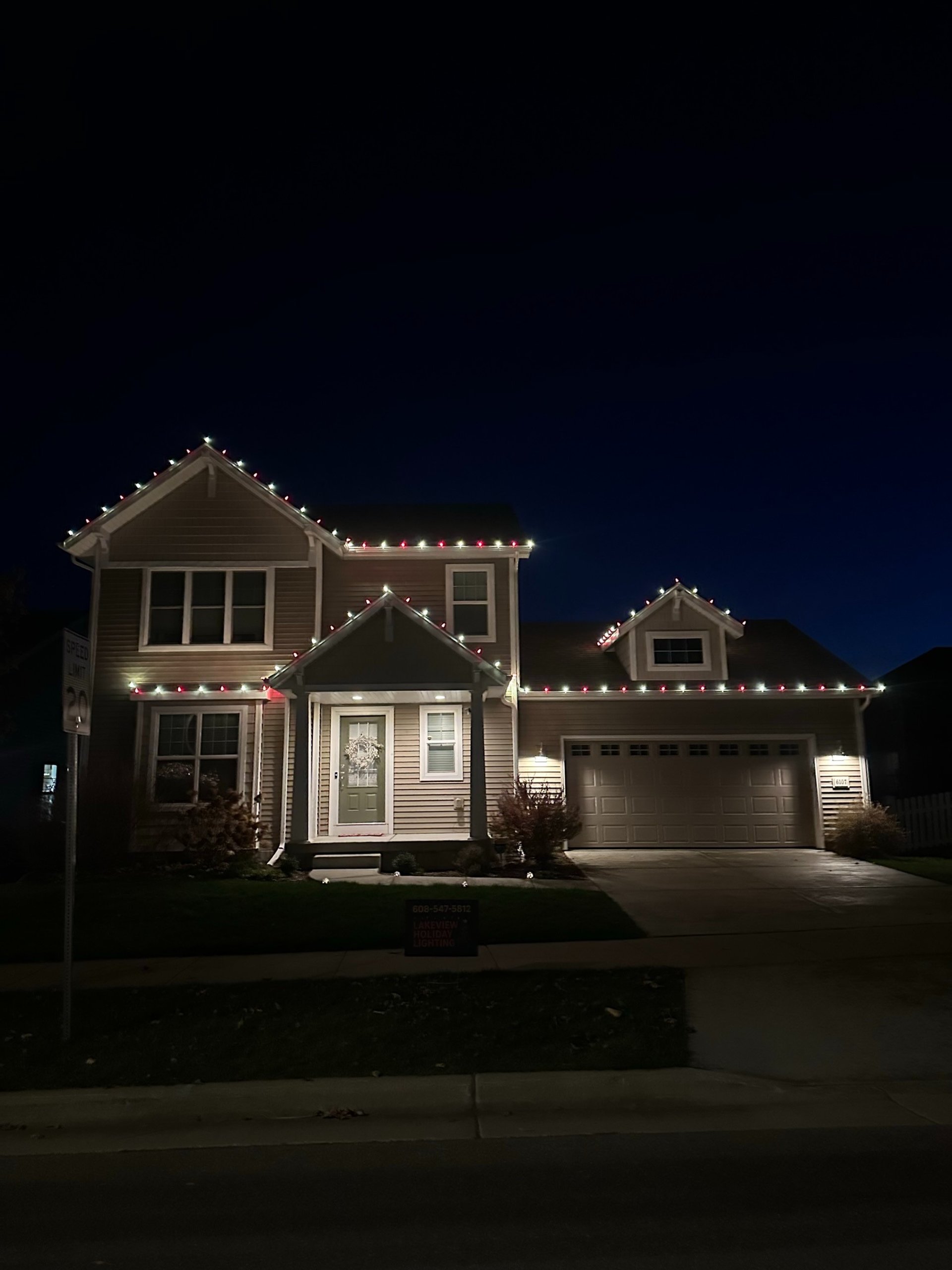 Illuminated buildings at night with colorful lights.