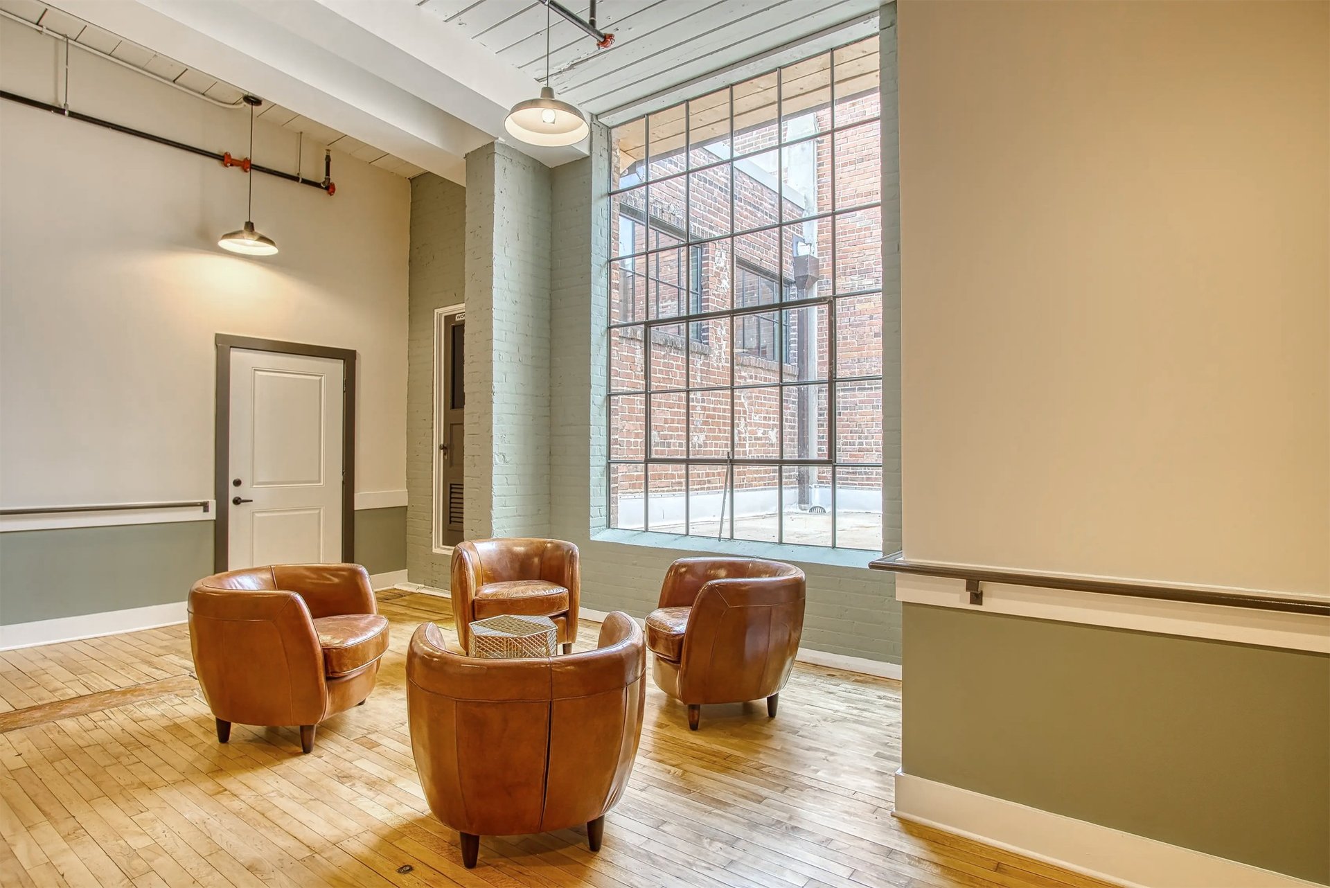 Aerial view of apartment buildings, parking, and landscaped green space at Arrogate Village in Summerville, SC.