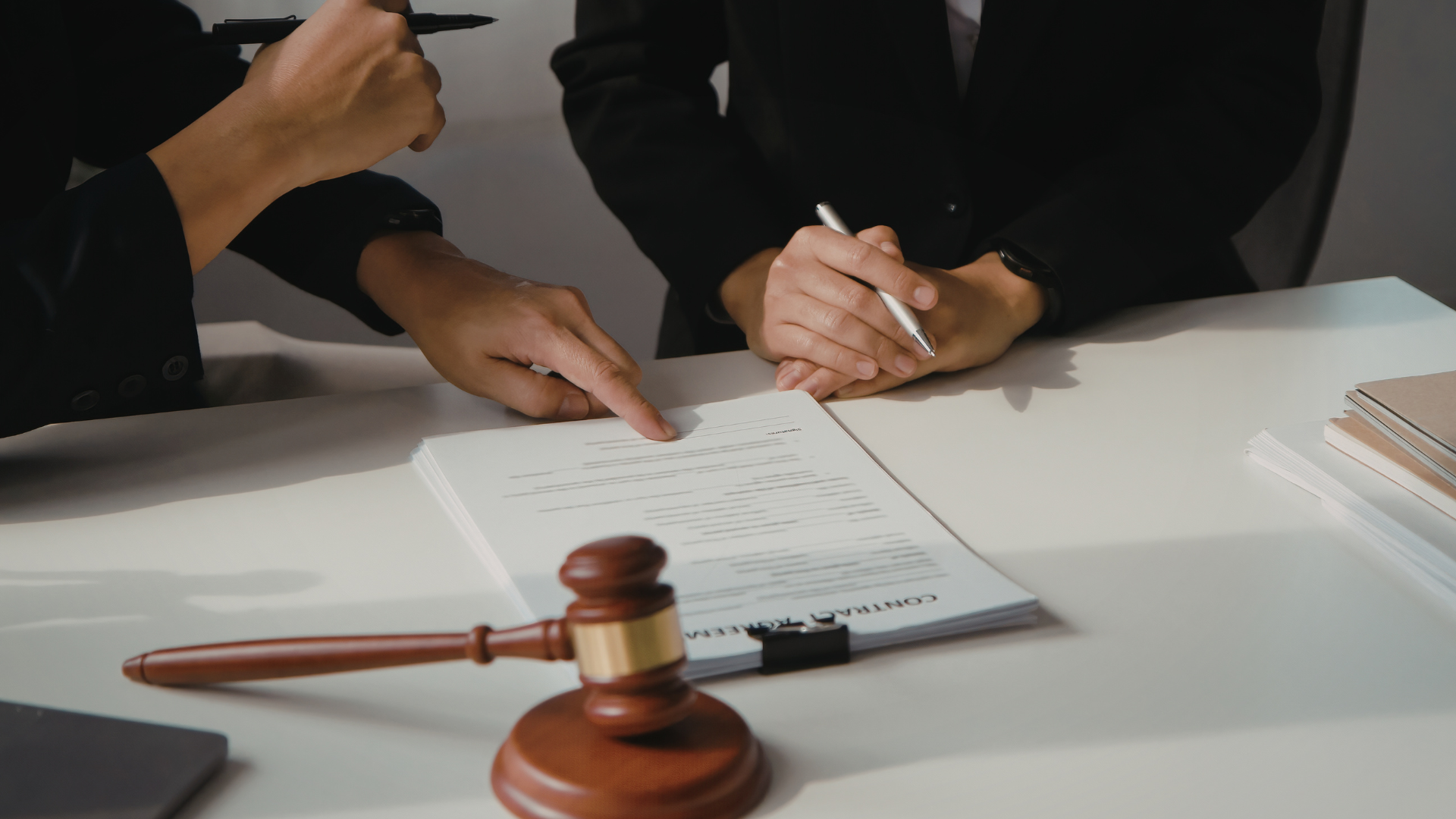 person in orange long sleeve shirt writing on white paper